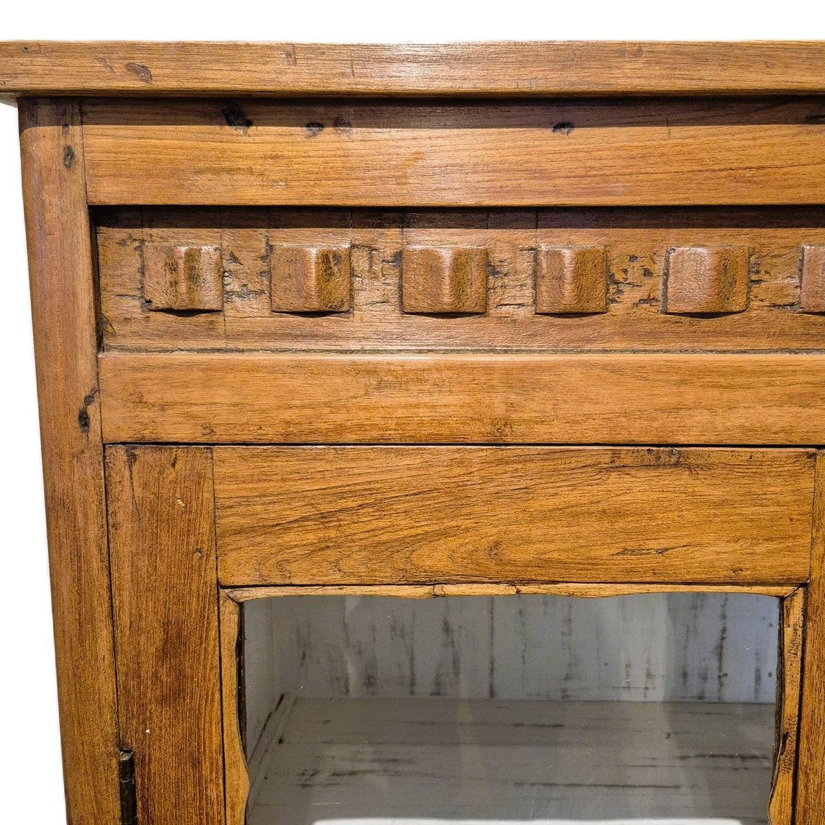 Glazed doors on the vintage teak cabinet open onto a whitewashed interior with two shelves, 94cm wide and 46cm deep