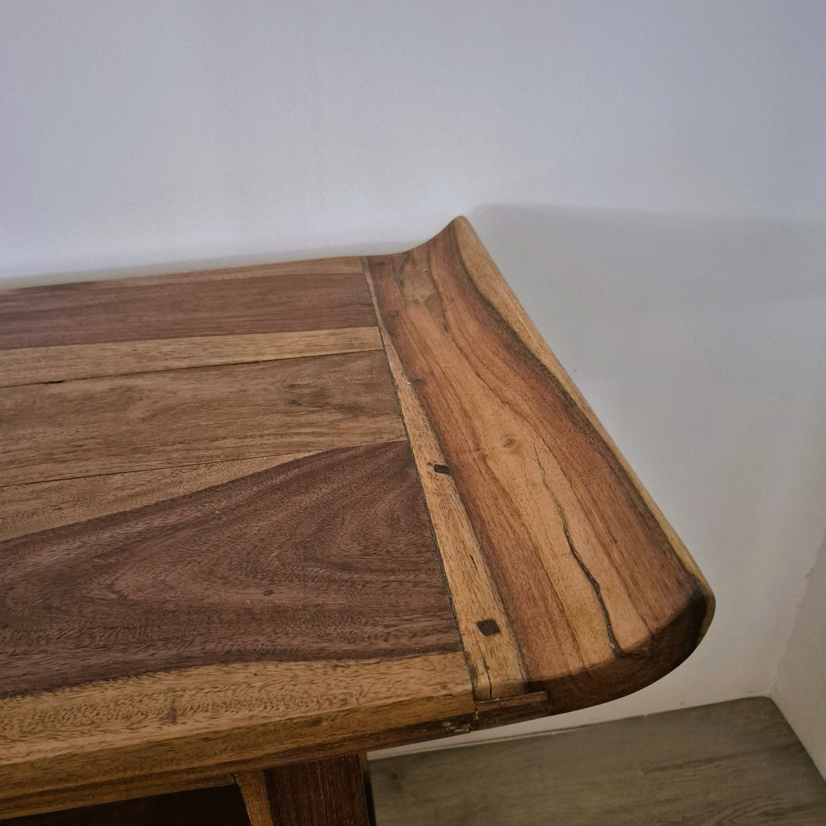 Hand crafted vintage teak console table, 154 cm long, with a gently curved edge sweeping up at the top