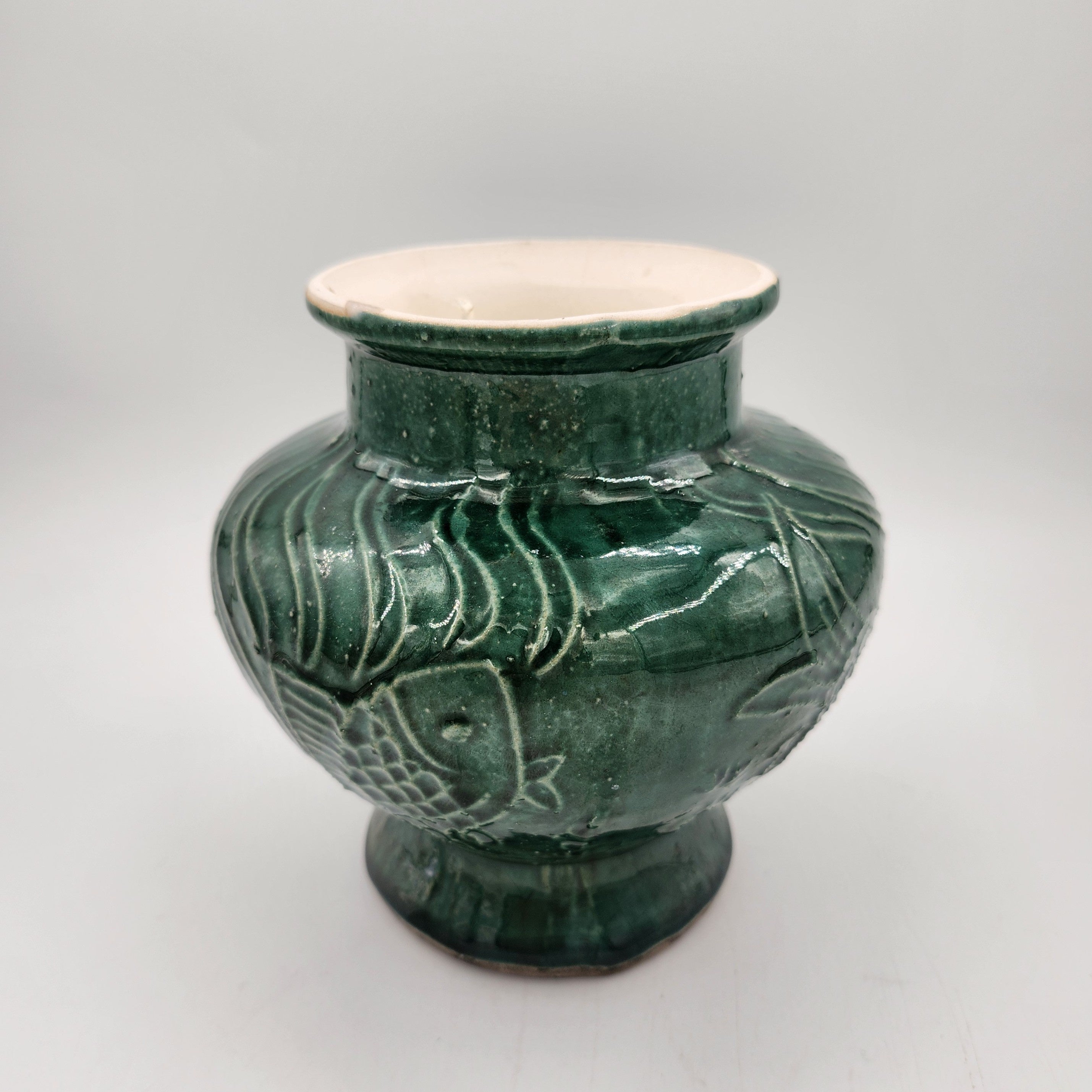 Jade Fish candle, green vase with fish design, styled view