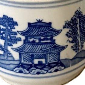 Pagoda candle, blue and white lidded pot, countryside vistas, styled view