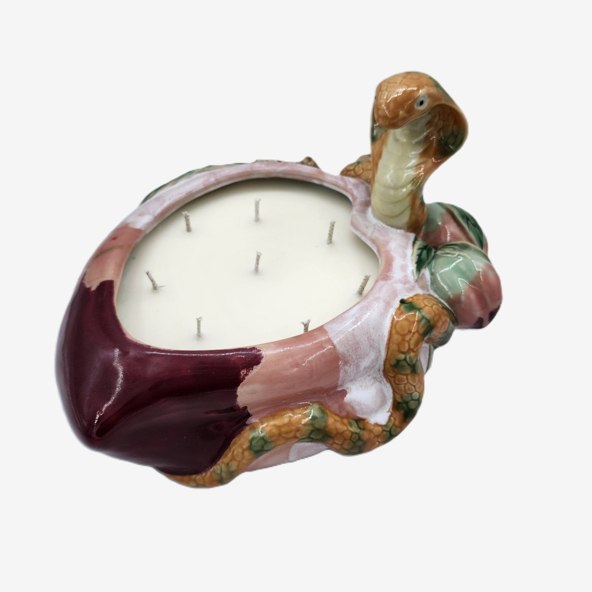 Legend candle, painted snake and plum ceramic jar, styled view