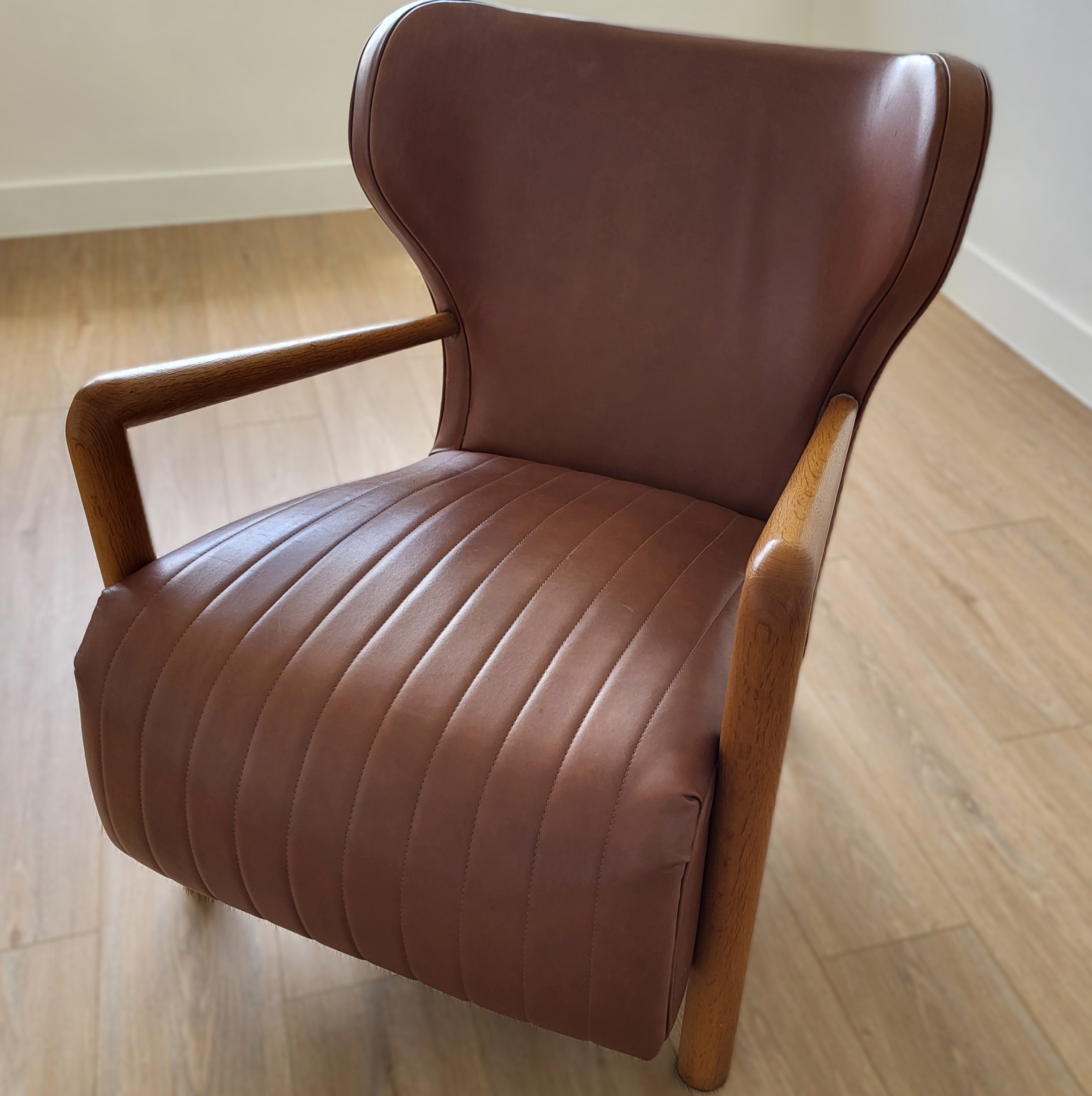 Wingback armchair, Jean Royère style, dusty rose leather seat, detail view