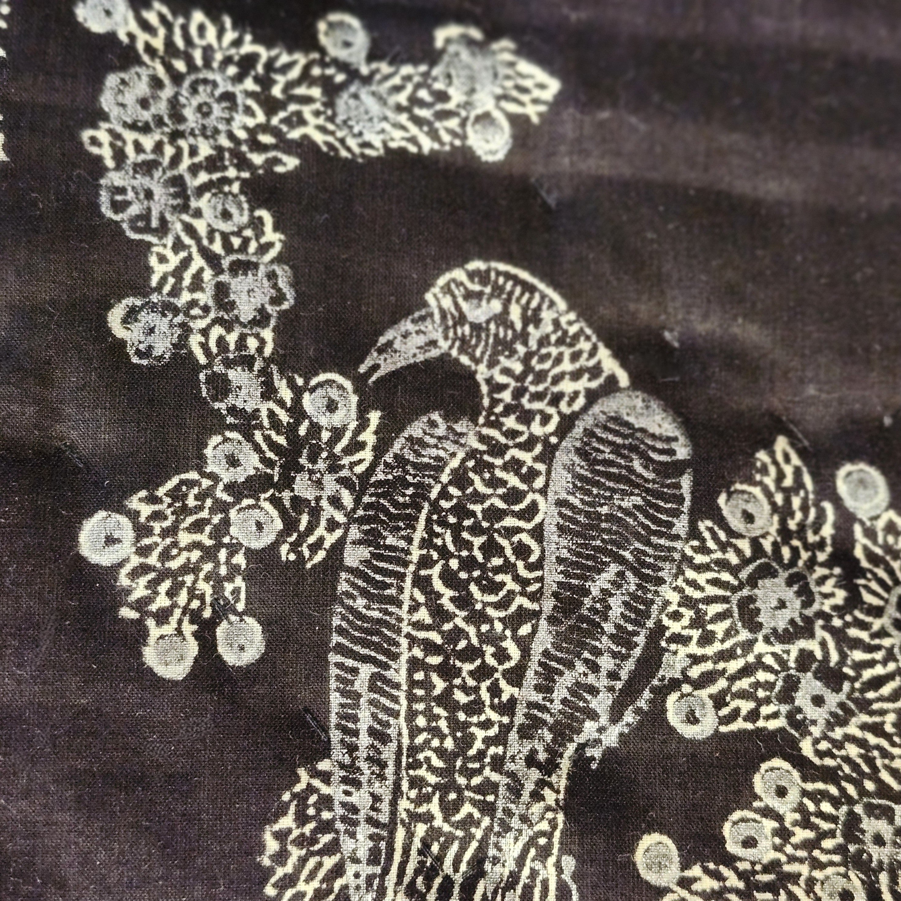 Close-up of silver birds of paradise block print on black voile
