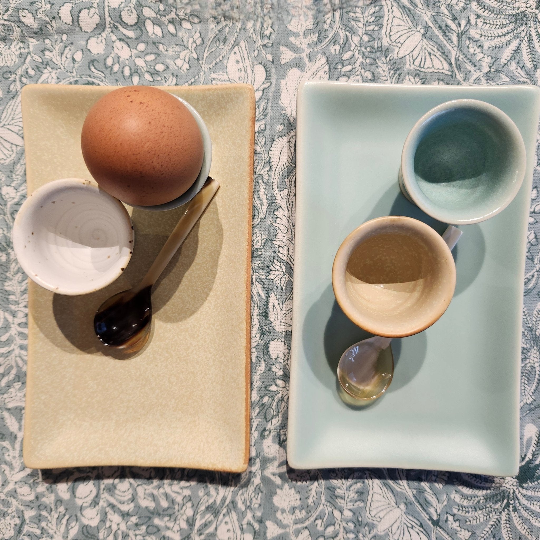 Egg cup sitting on a ceramic tray dish