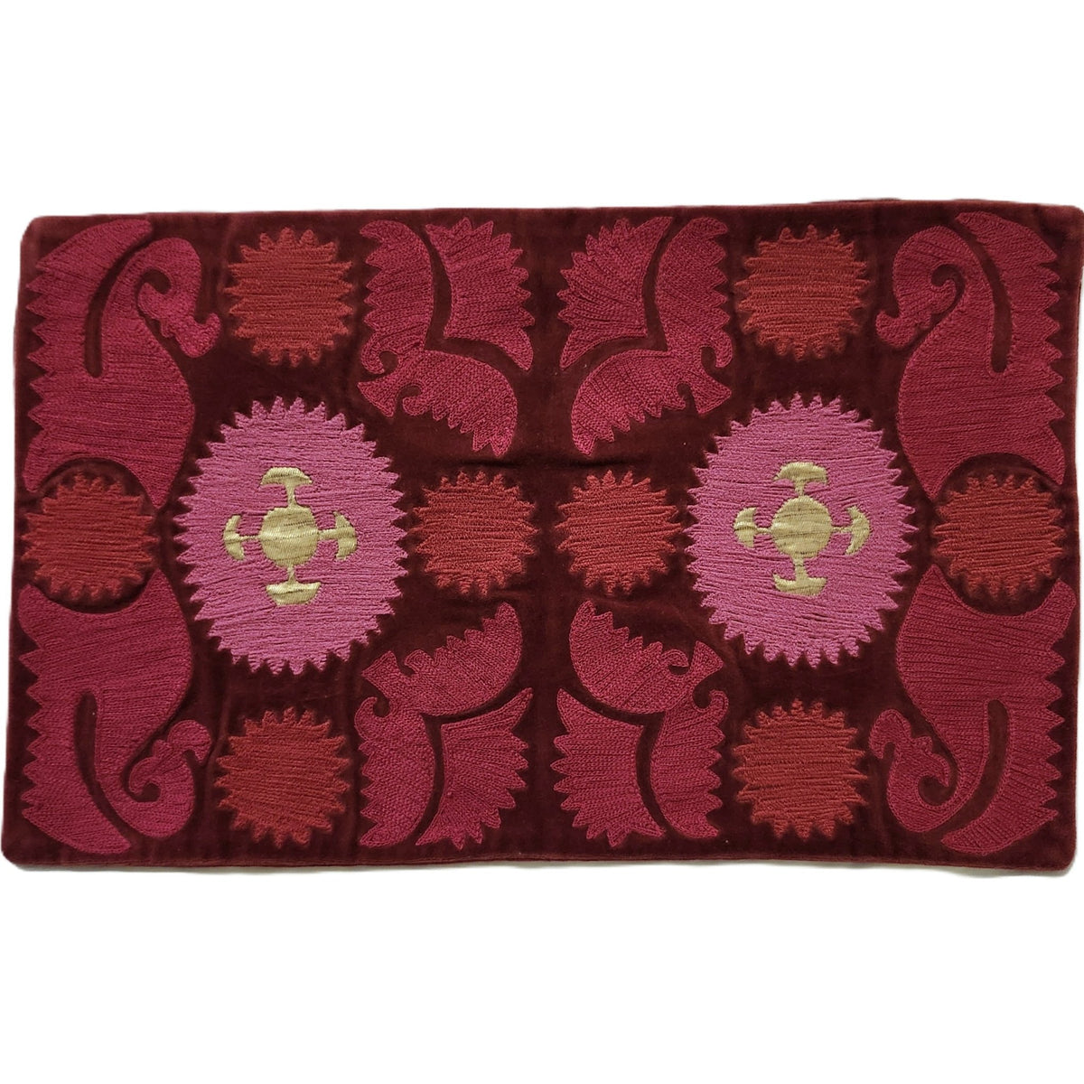Hand embroidered cotton velvet cushion cover in a kilim style pattern of red, pink and gold, 30 by 50cm.