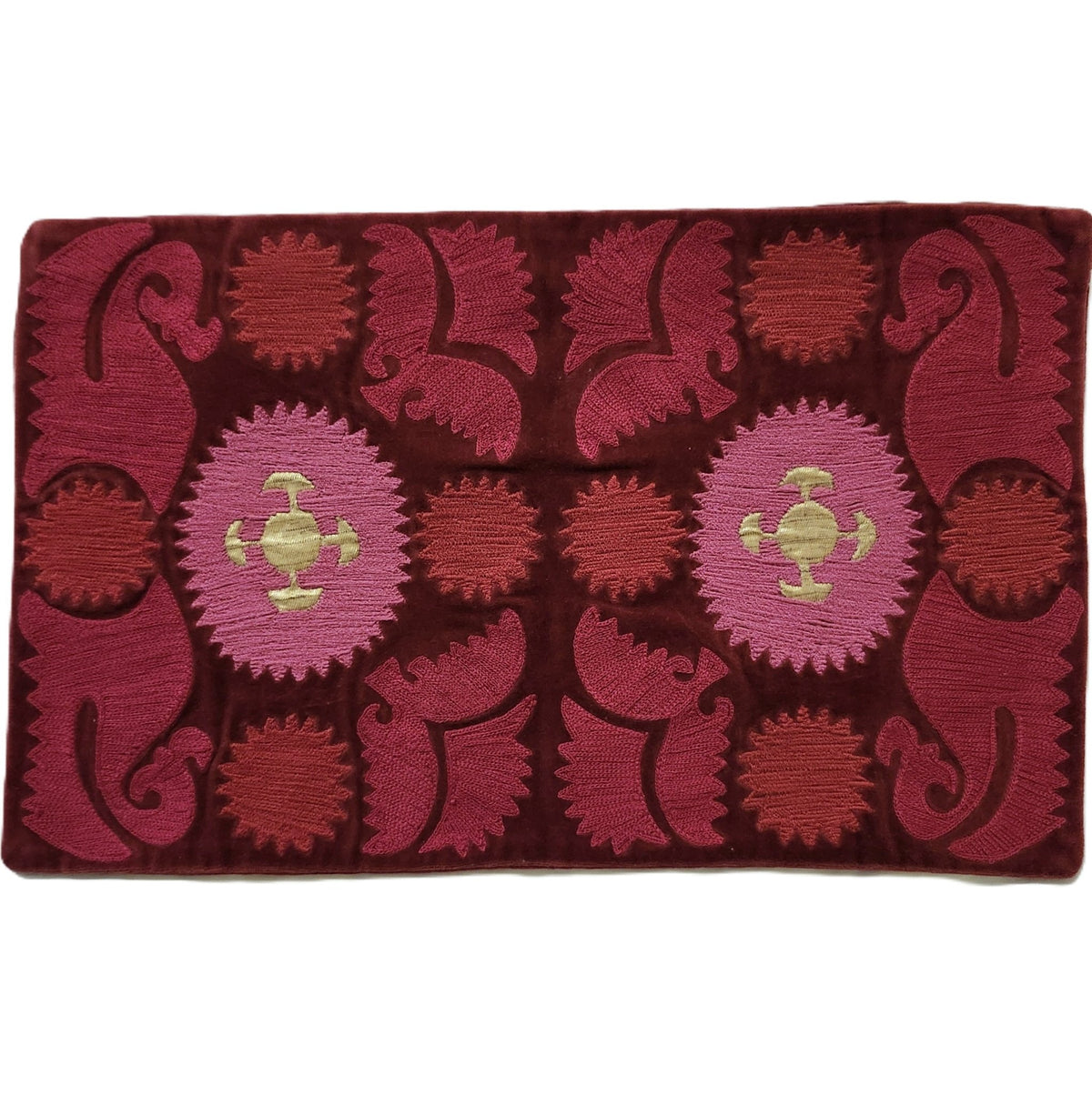 Hand embroidered cotton velvet cushion cover in a kilim style pattern of red, pink and gold, 30 by 50cm.