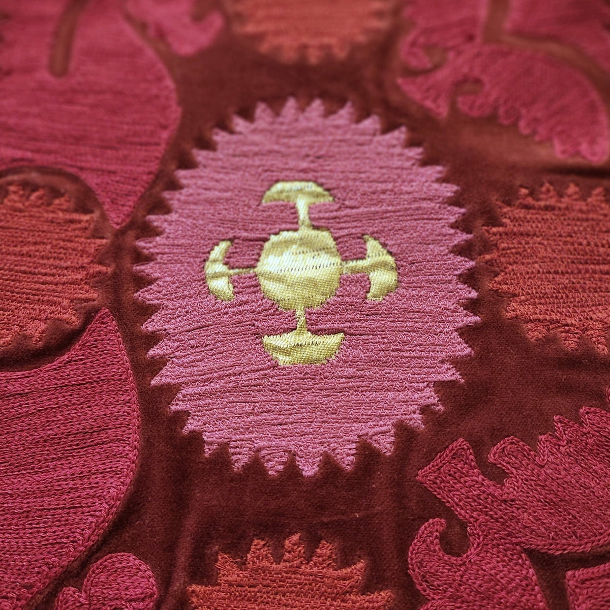 Detail of the Bodum cushion, hand embroidered in India in red, pink and gold on cotton velvet.