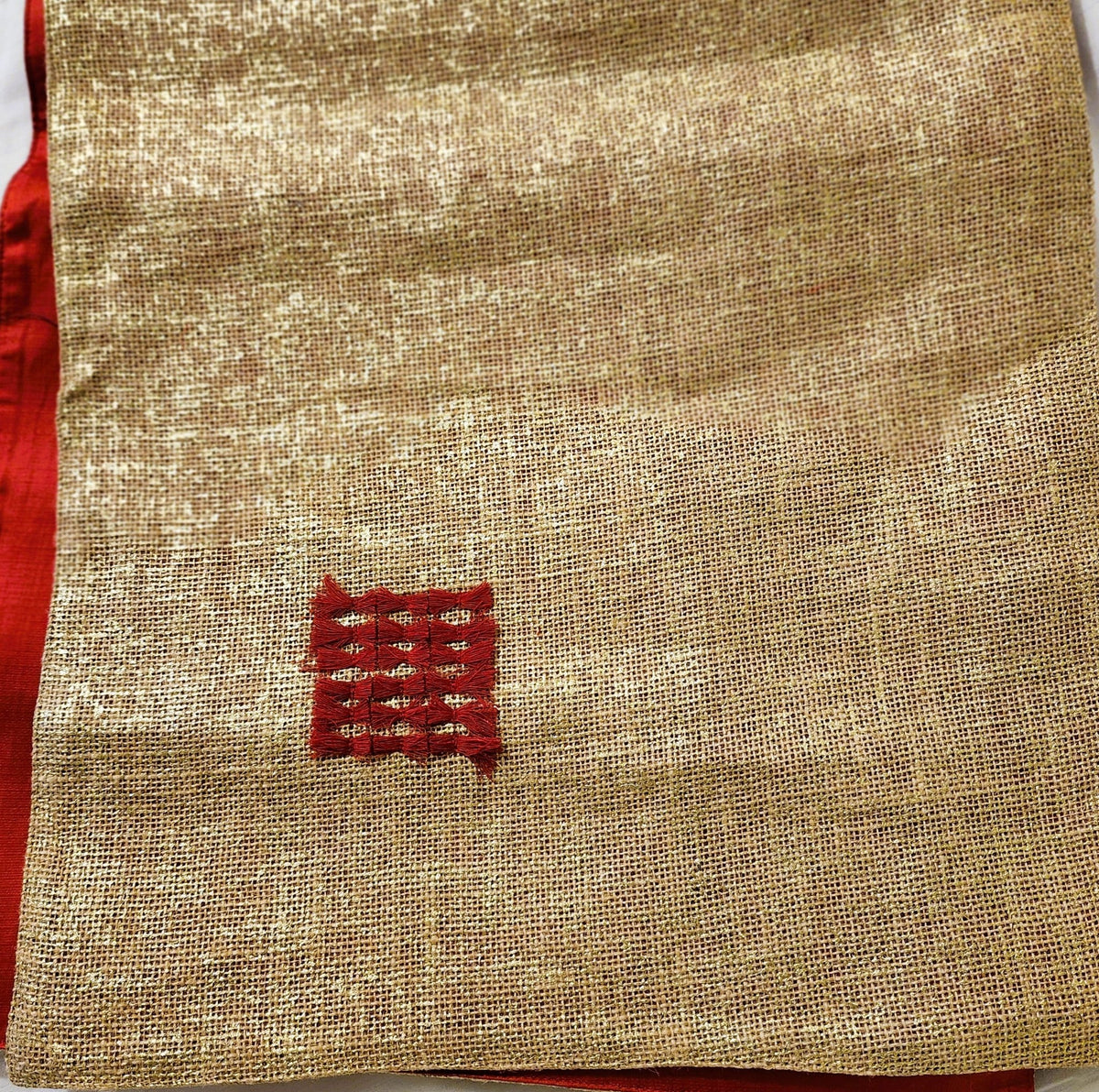 The red silk reverse of the hand woven gold and red table runner, made in India, 40 by 250cm.