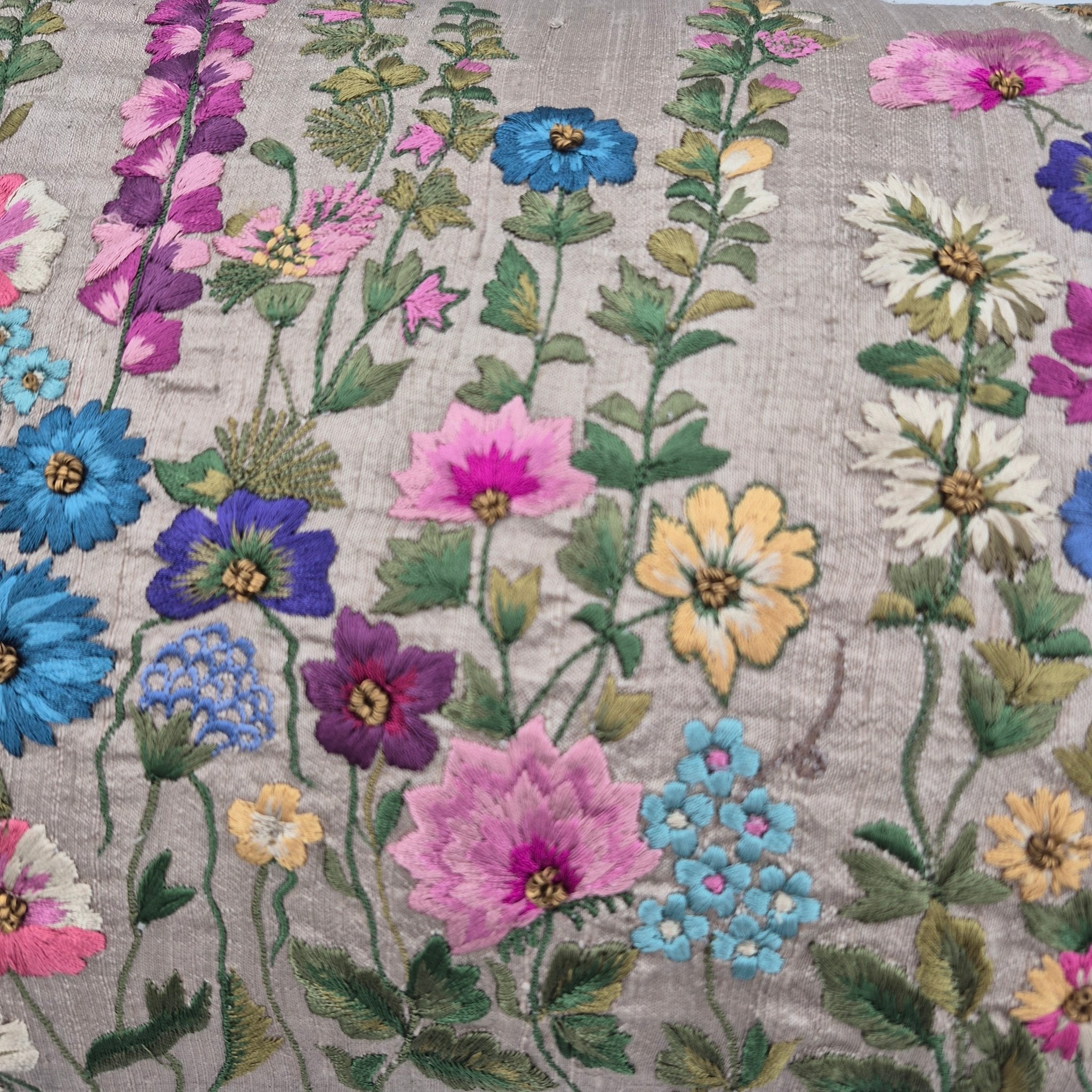 Close up of embroidery on raw silk flowers cushion
