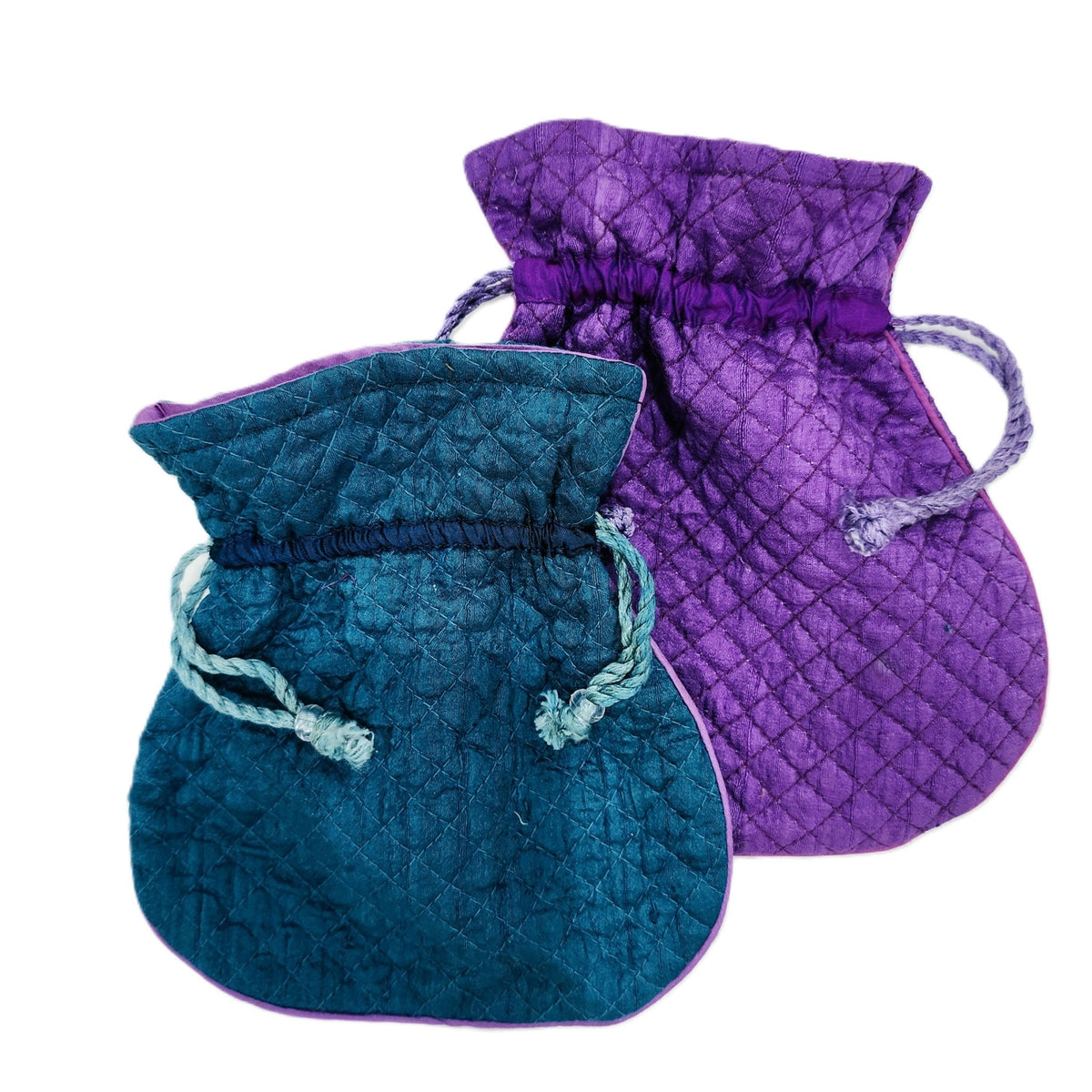 Quilted pure silk pouches in peacock blue and amethyst, each with a pink silk lining and string closure.