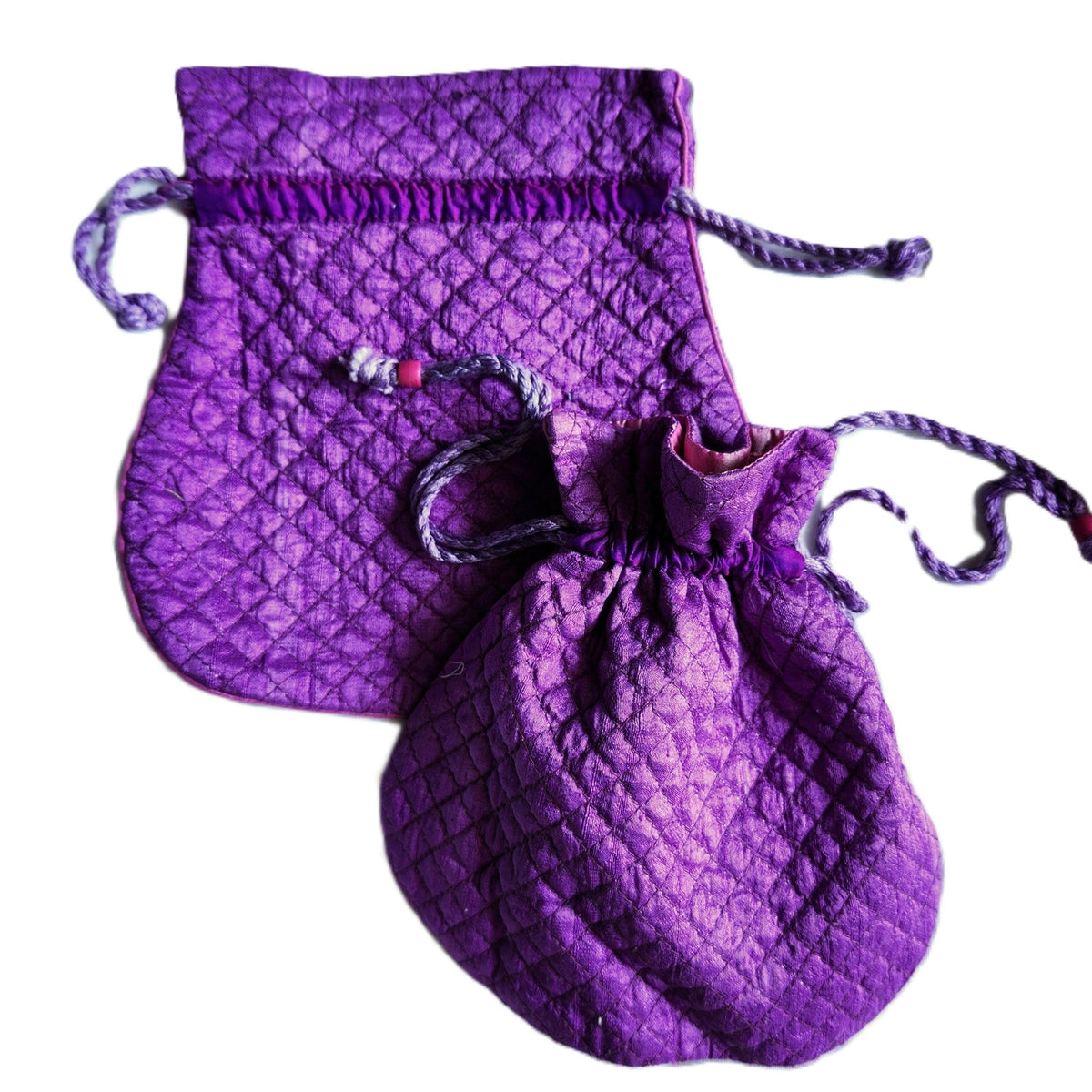 Amethyst silk pouch, 18.5cm wide by 18cm high, quilted pure silk with a pink lining and string tie.