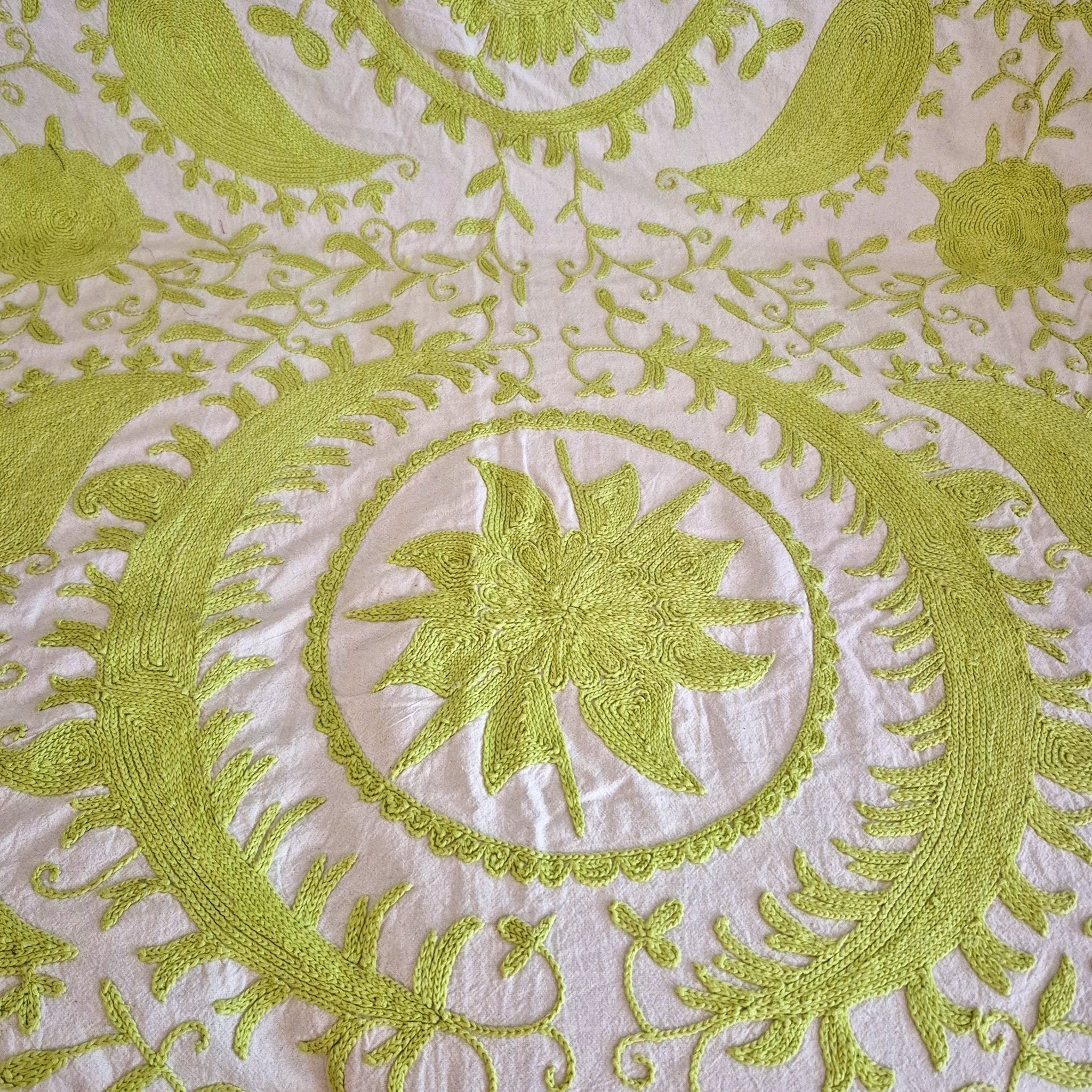 Hand embroidered suzani throw in lime green on cream background
