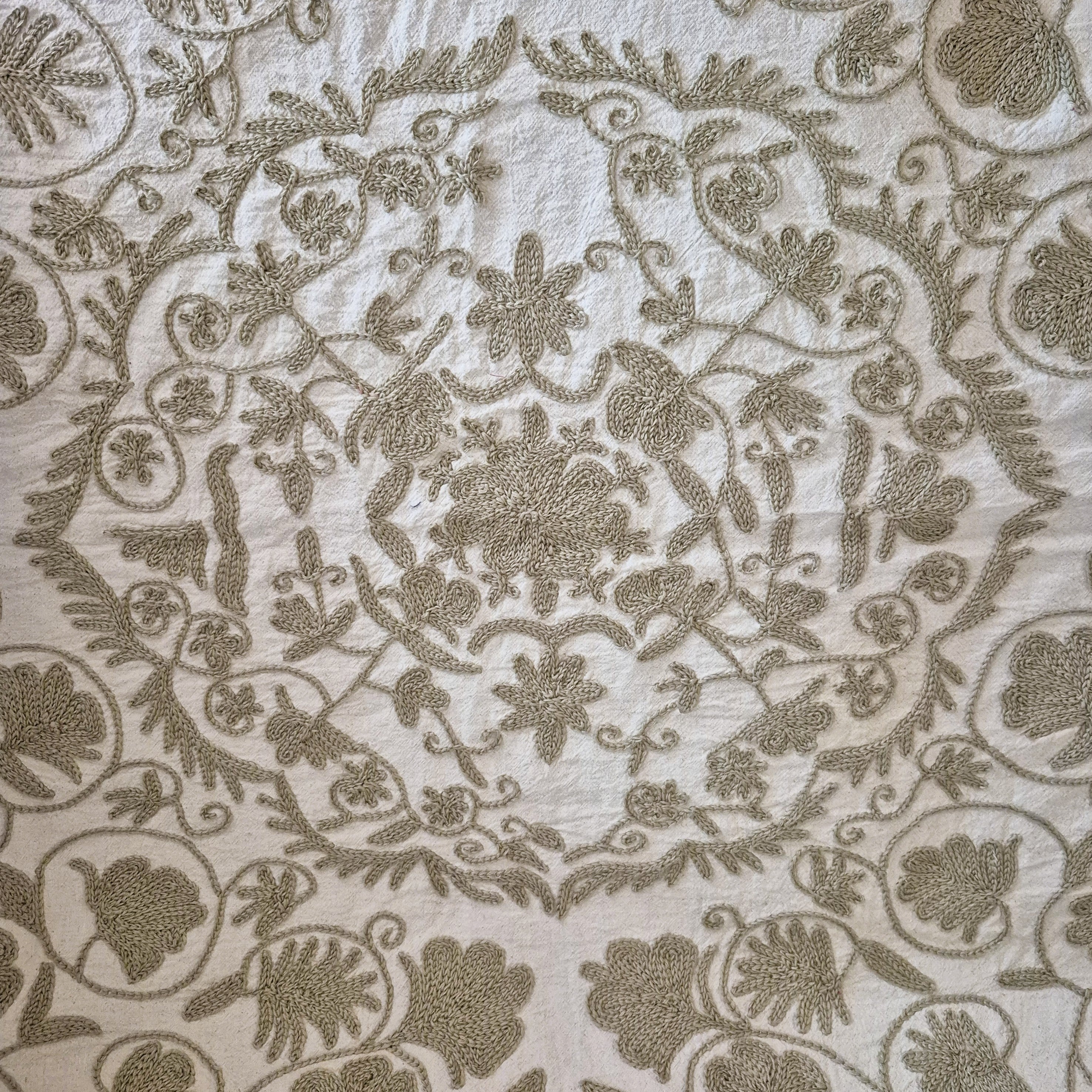Hand Embroidered suzani in beige on a cream background