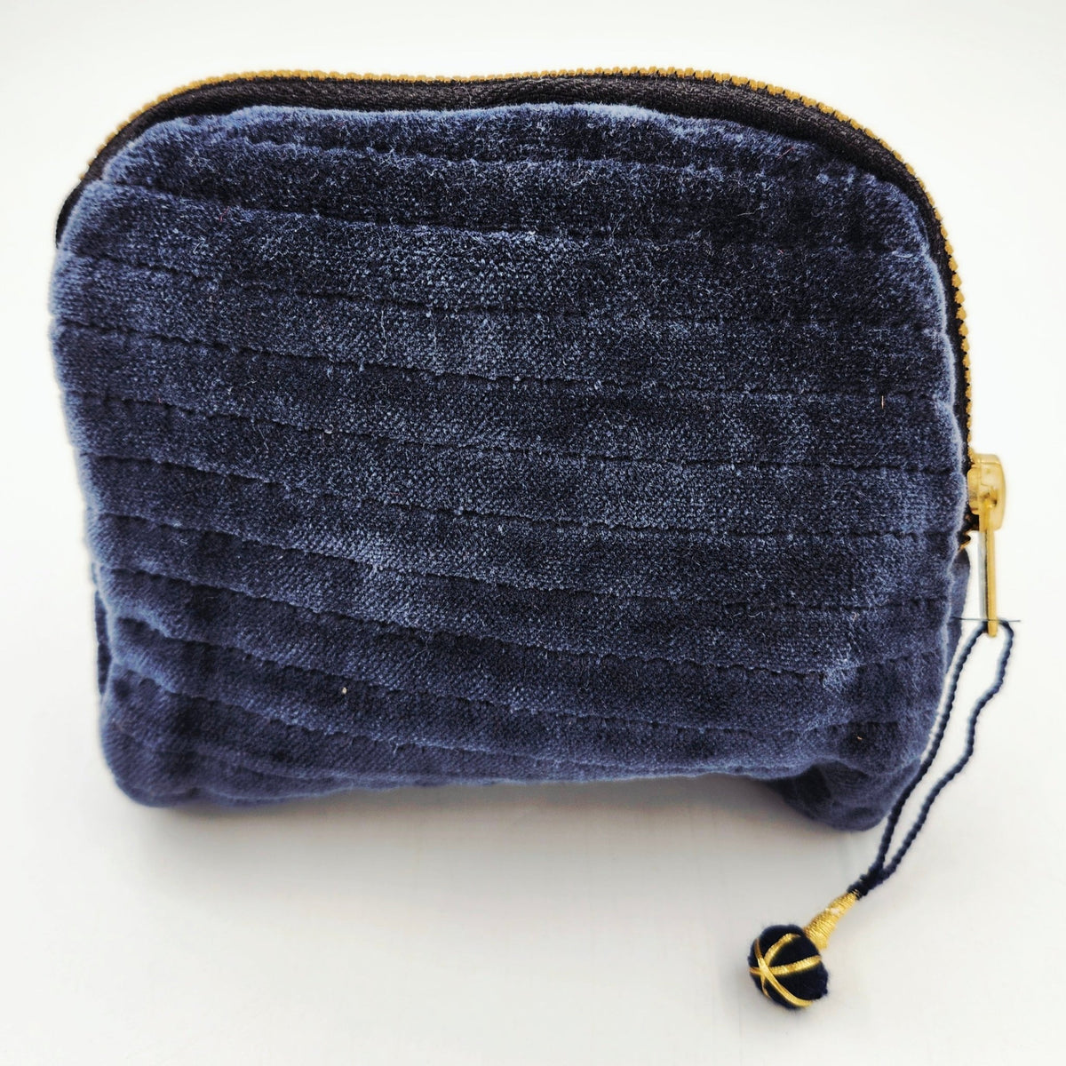 Velvet pouch in midnight, lined with a complementary block print and closed with a brass zip, 5 inches.