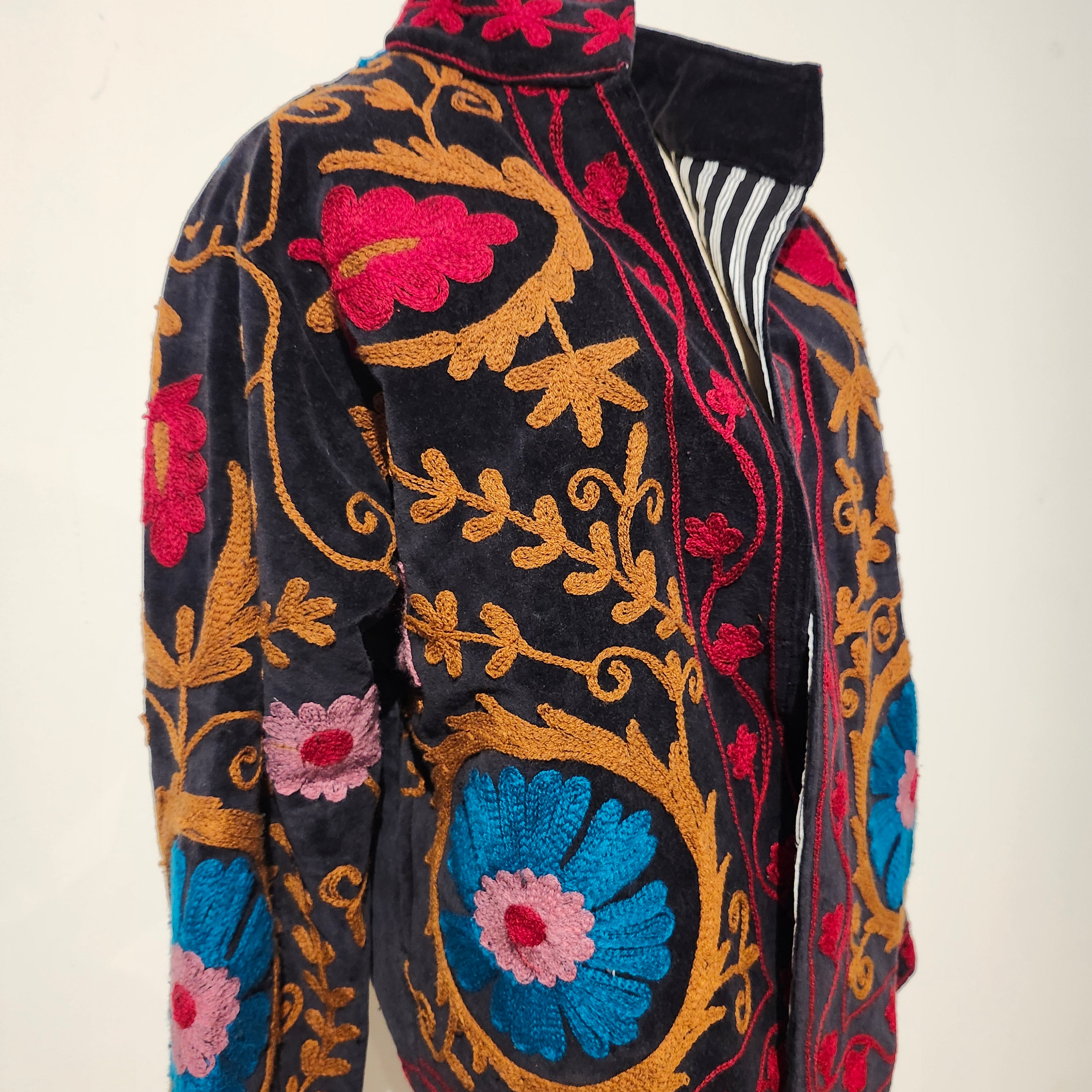 Black velvet jacket with hand-worked suzani stitching, striped cotton lining