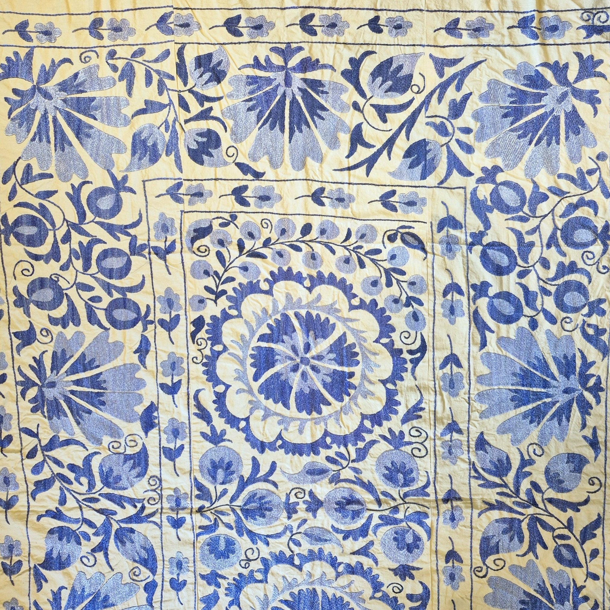 Vintage Suzani in blue on cream background