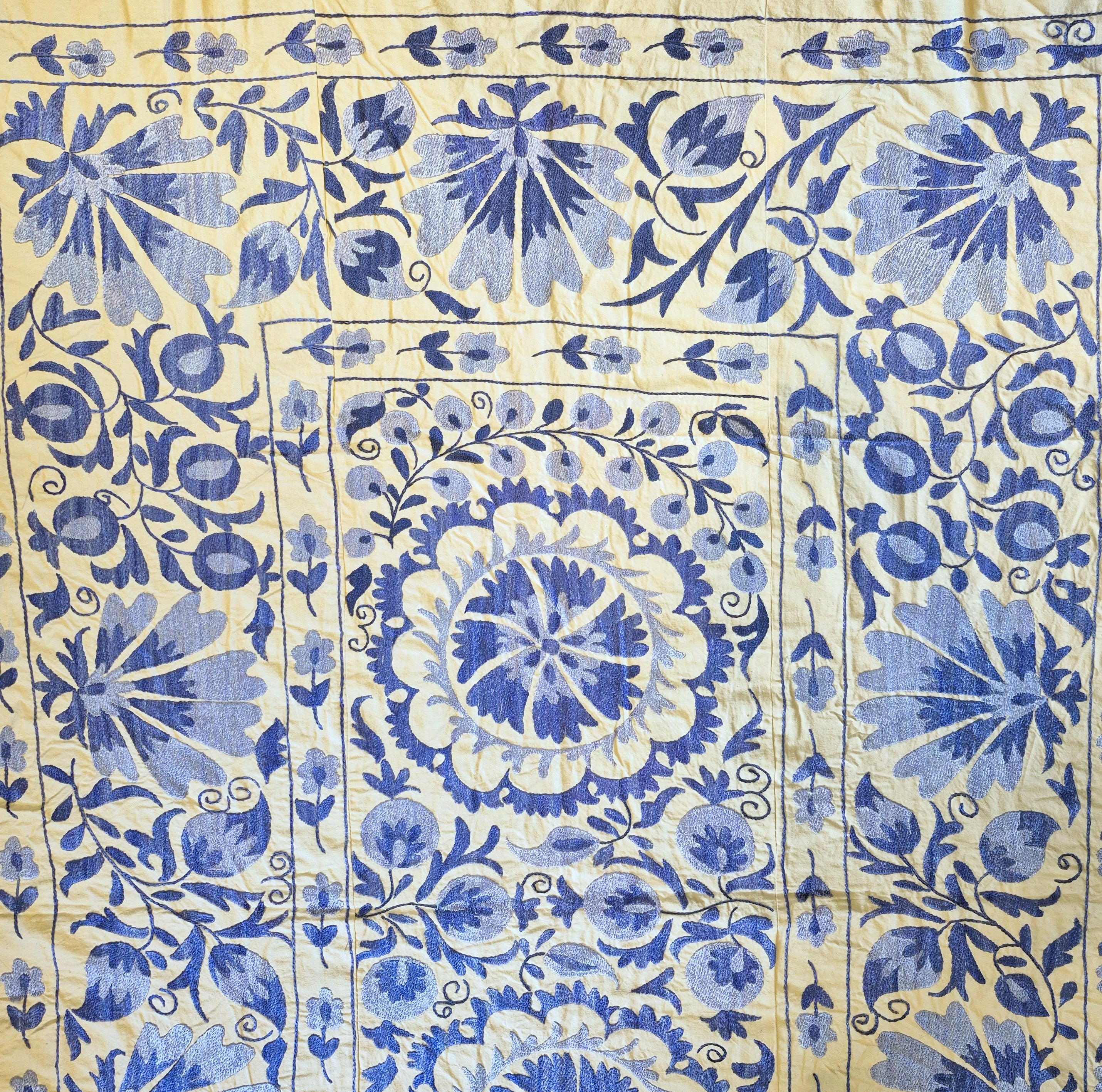 Vintage Suzani in blue on cream background