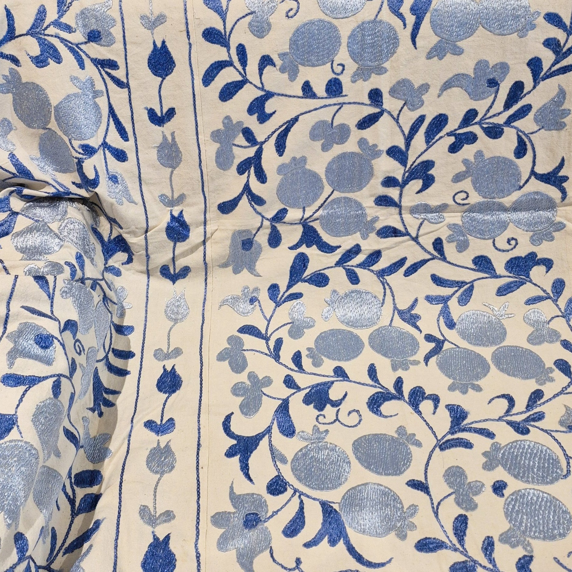 Suzani with blue pomegranate and leaf pattern on cream background