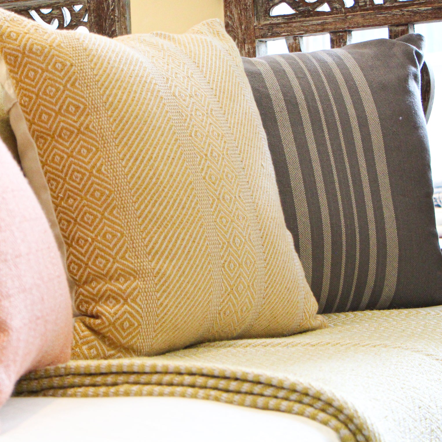 Grey and linen Antibes cushion by Weaver Green, styled in a room