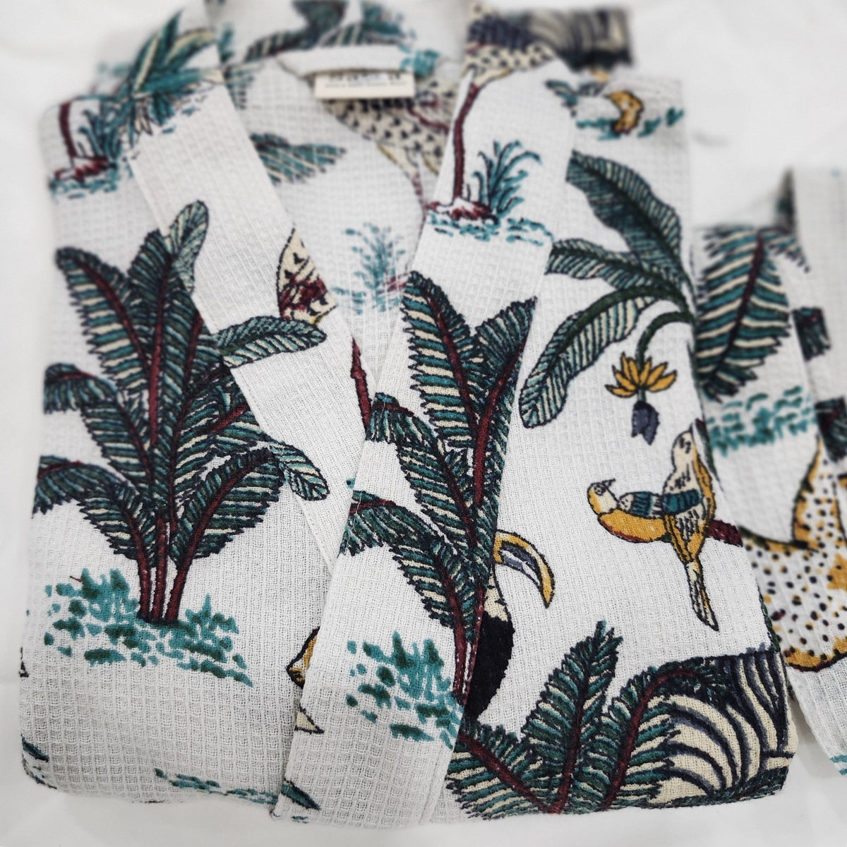 Cotton waffle dressing gown with an all over safari block print, a belt and two large pockets, 128cm.