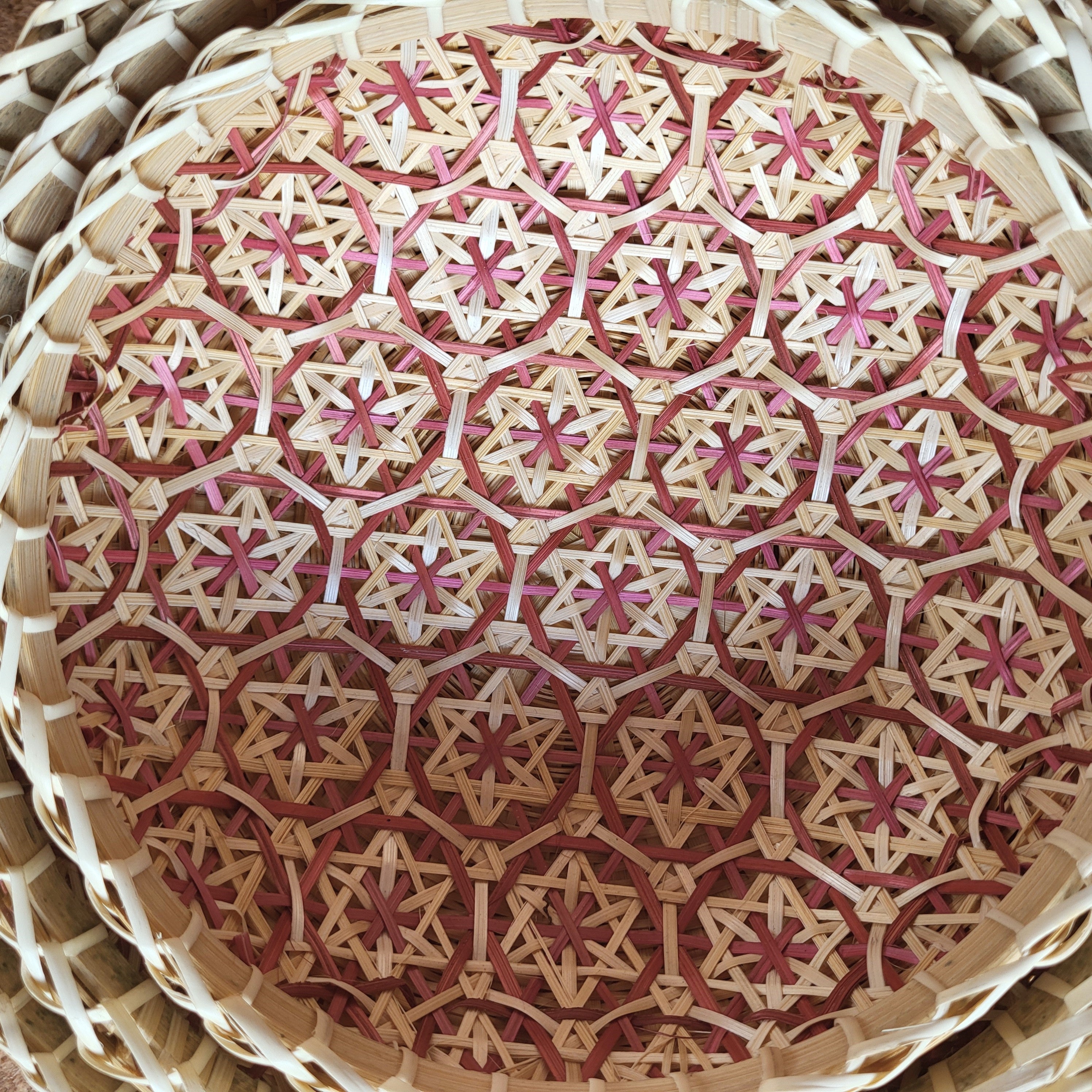 Round woven wicker basket with pink mosaic interior, handcrafted storage basket