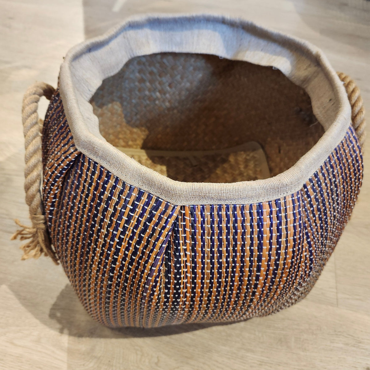 Medium wicker basket with a dark stripe and rope handles, 30cm high and 27cm in diameter, handy for laundry storage