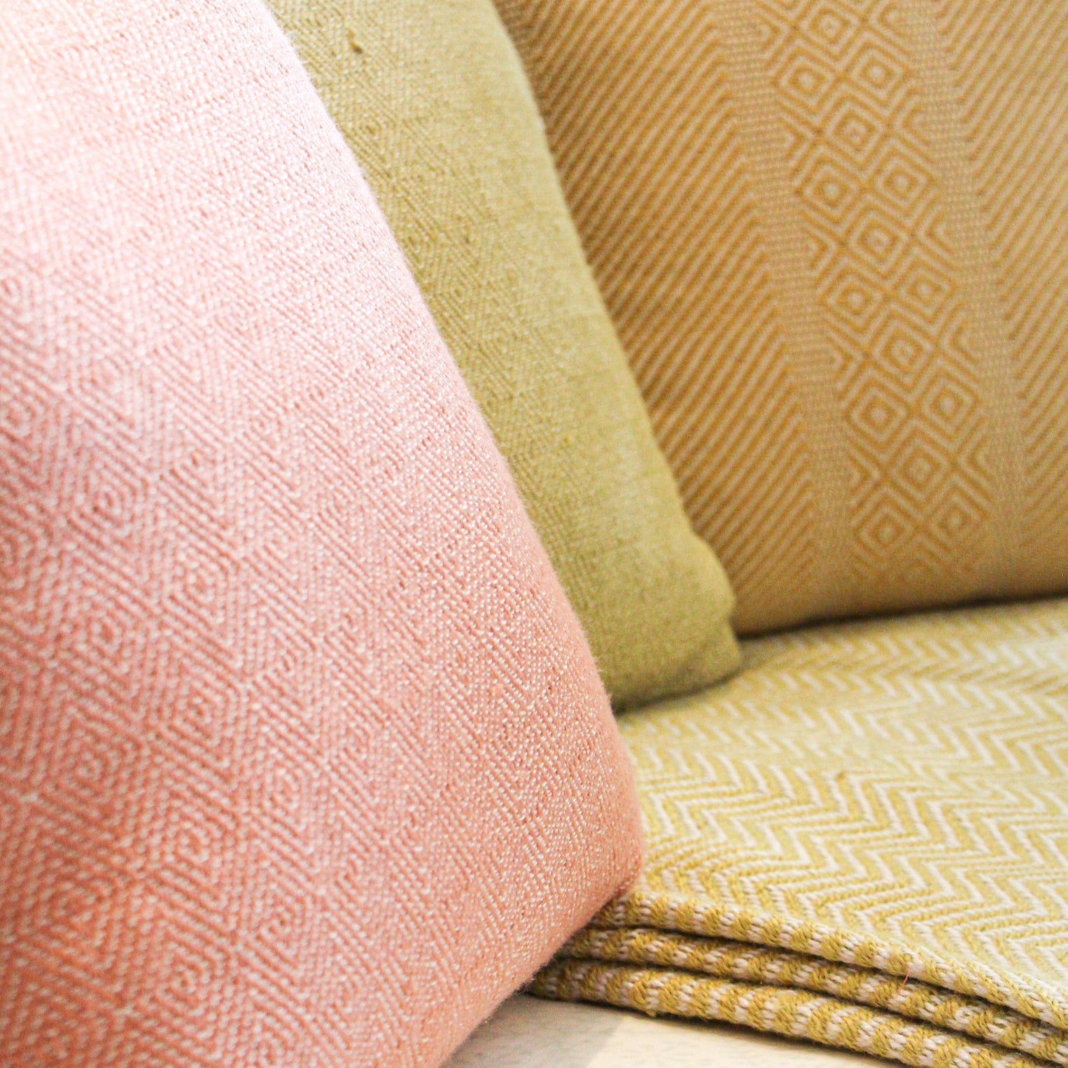 Coral diamond-pattern cushion by Weaver Green, recycled yarn, 45 cm