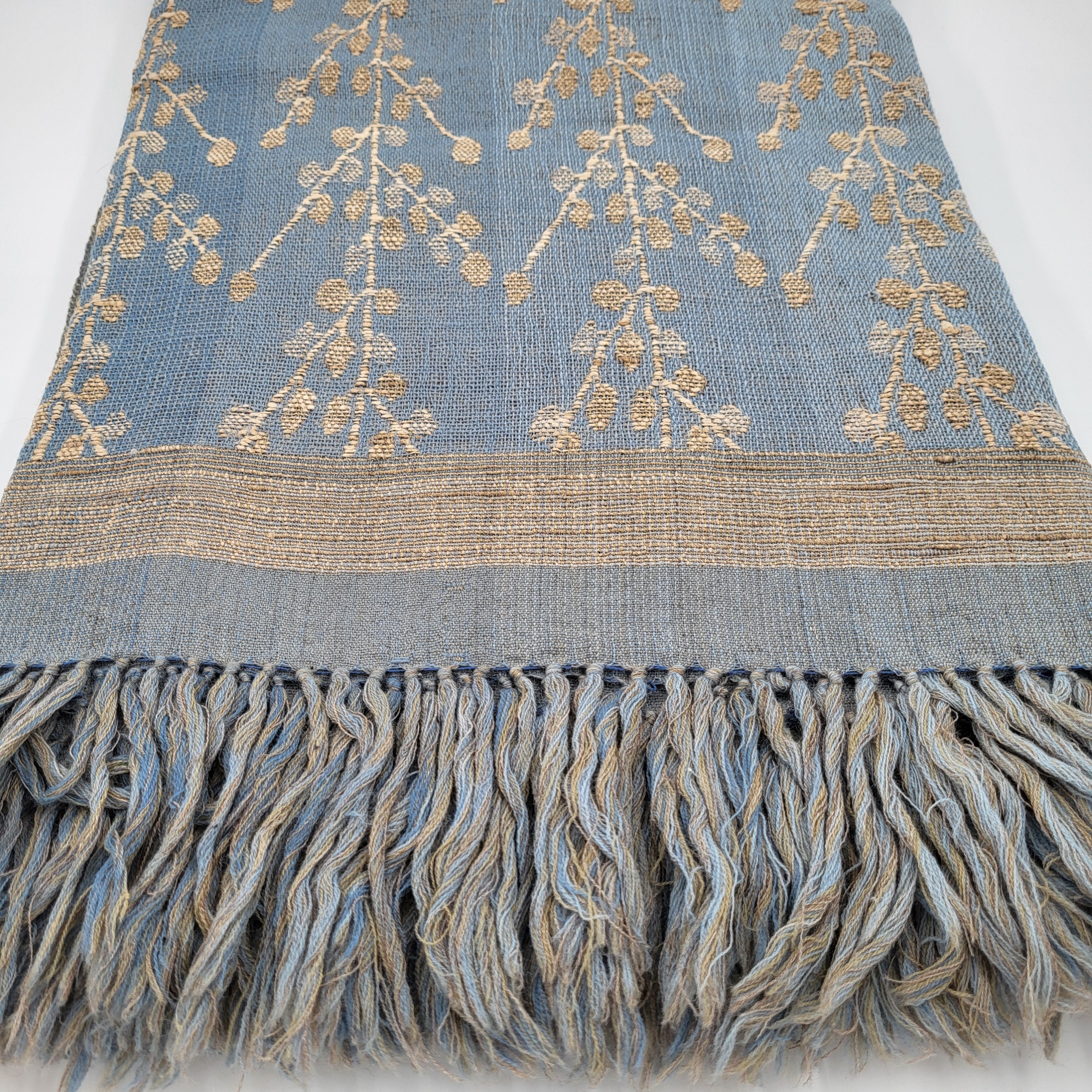Handwoven silk and wool throw with sky blue leaf design, fringed