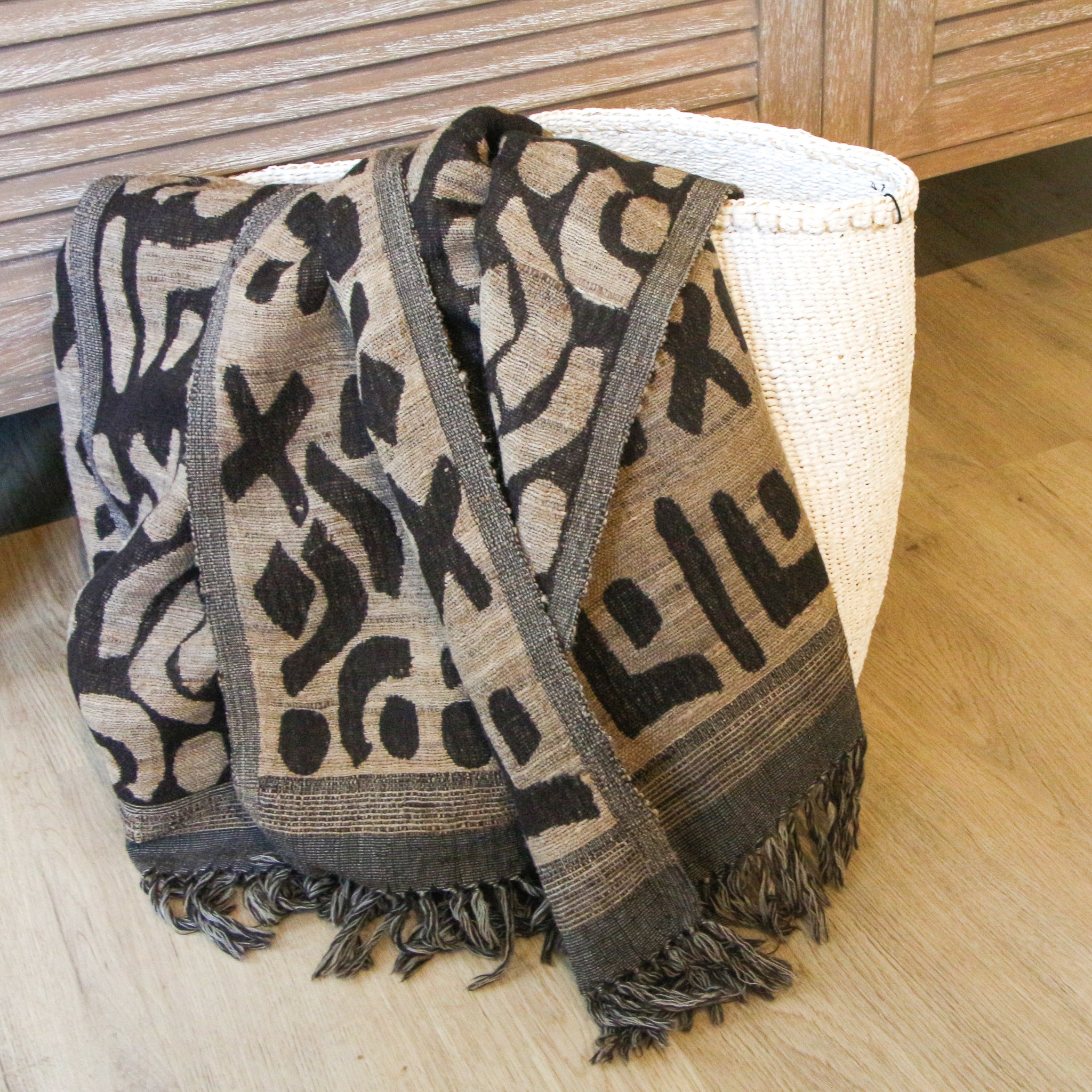 Handwoven silk and wool throw styled on a sofa, India