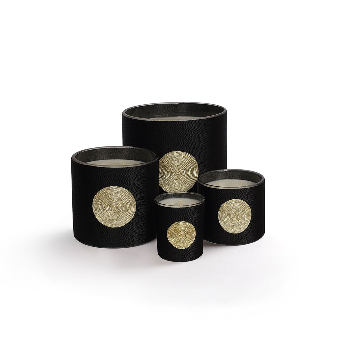 Sabra Dana Oud candle, black silk-wrapped jar, styled view