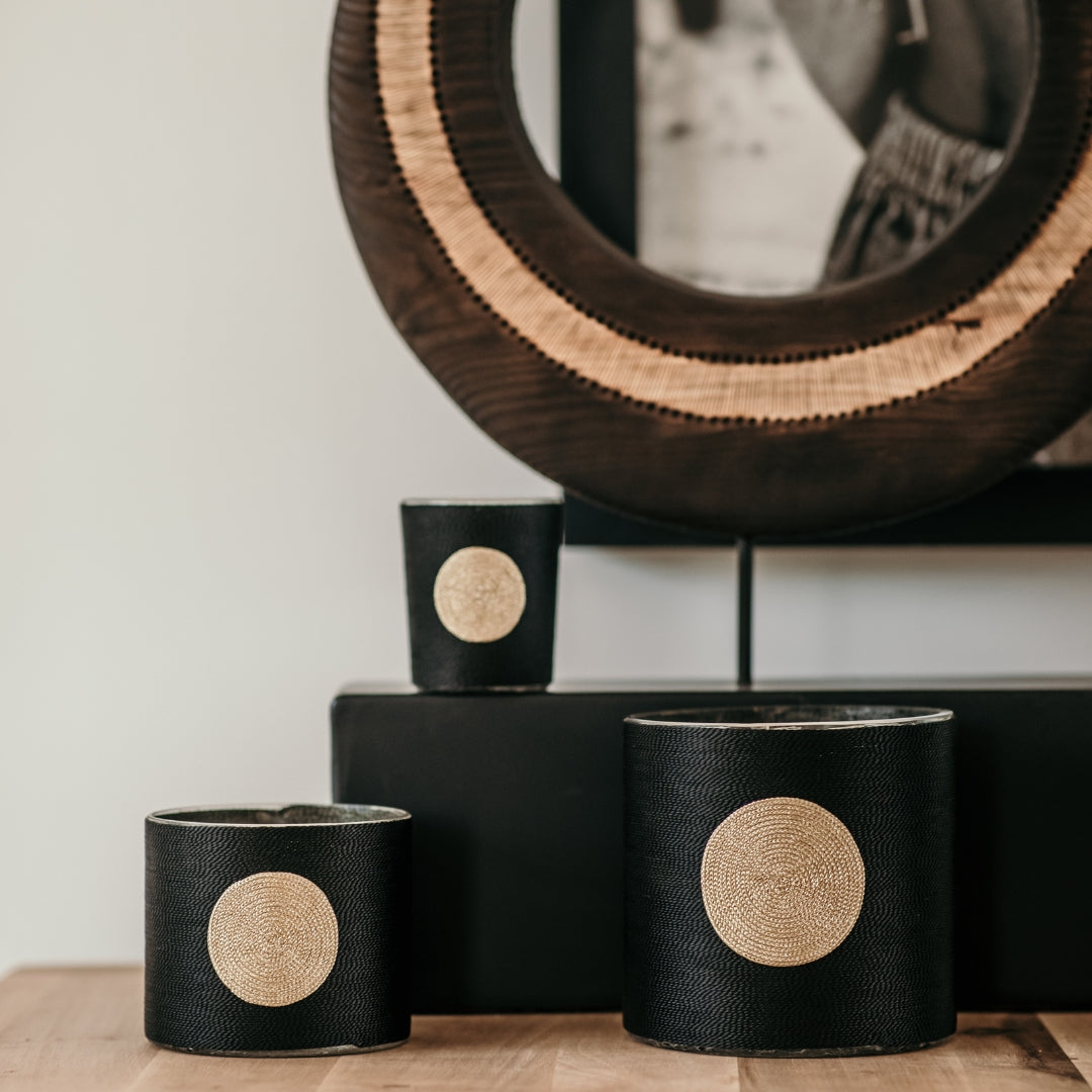 Sabra Dana Oud candle wrapped in black plant silk with a golden ribbon, oud scent