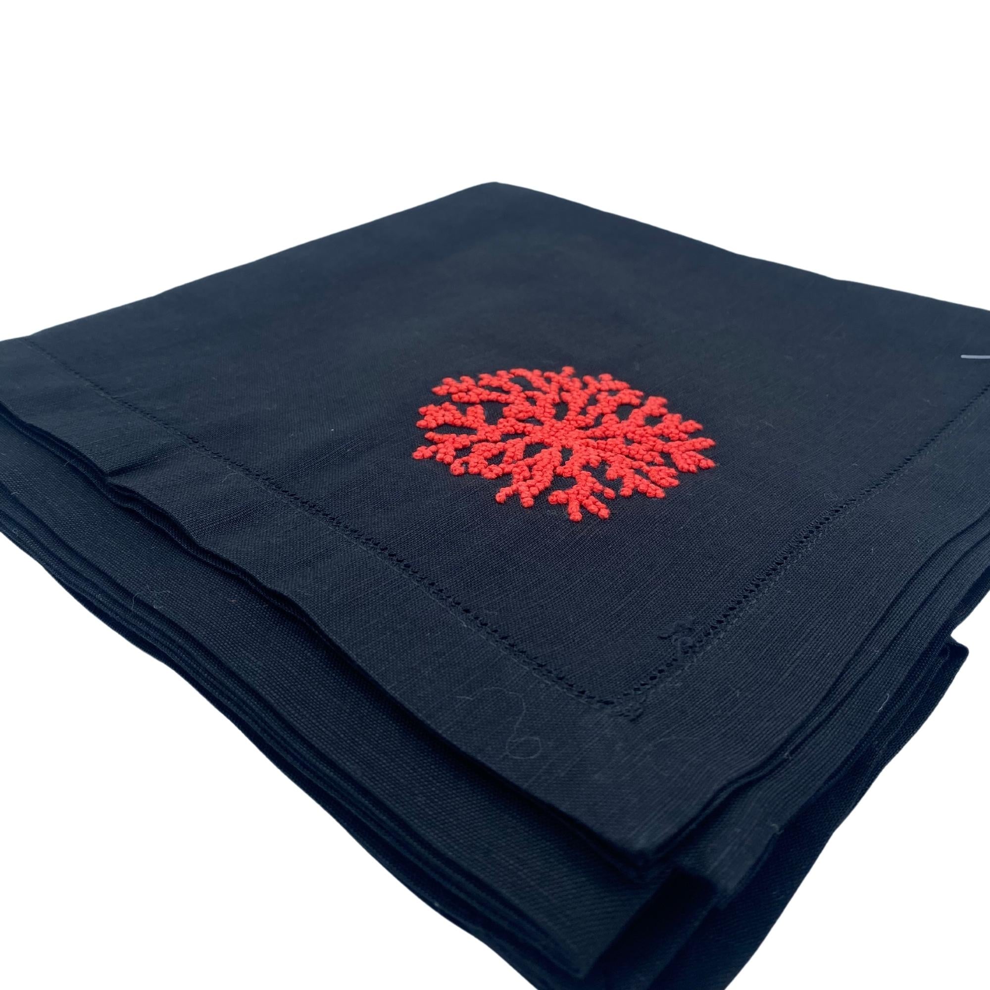 Black linen napkin with red and blue coral embroidery, detail view