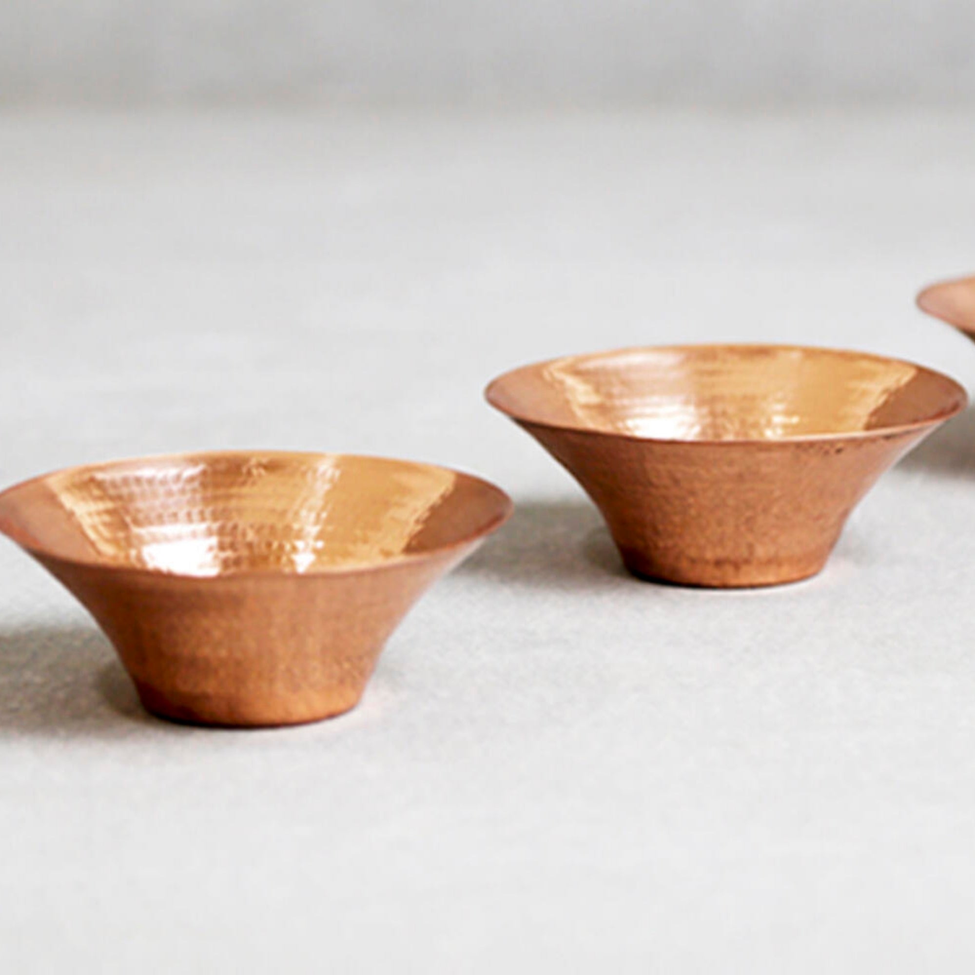 Hand-beaten copper tea light holder, detail of the hammered finish