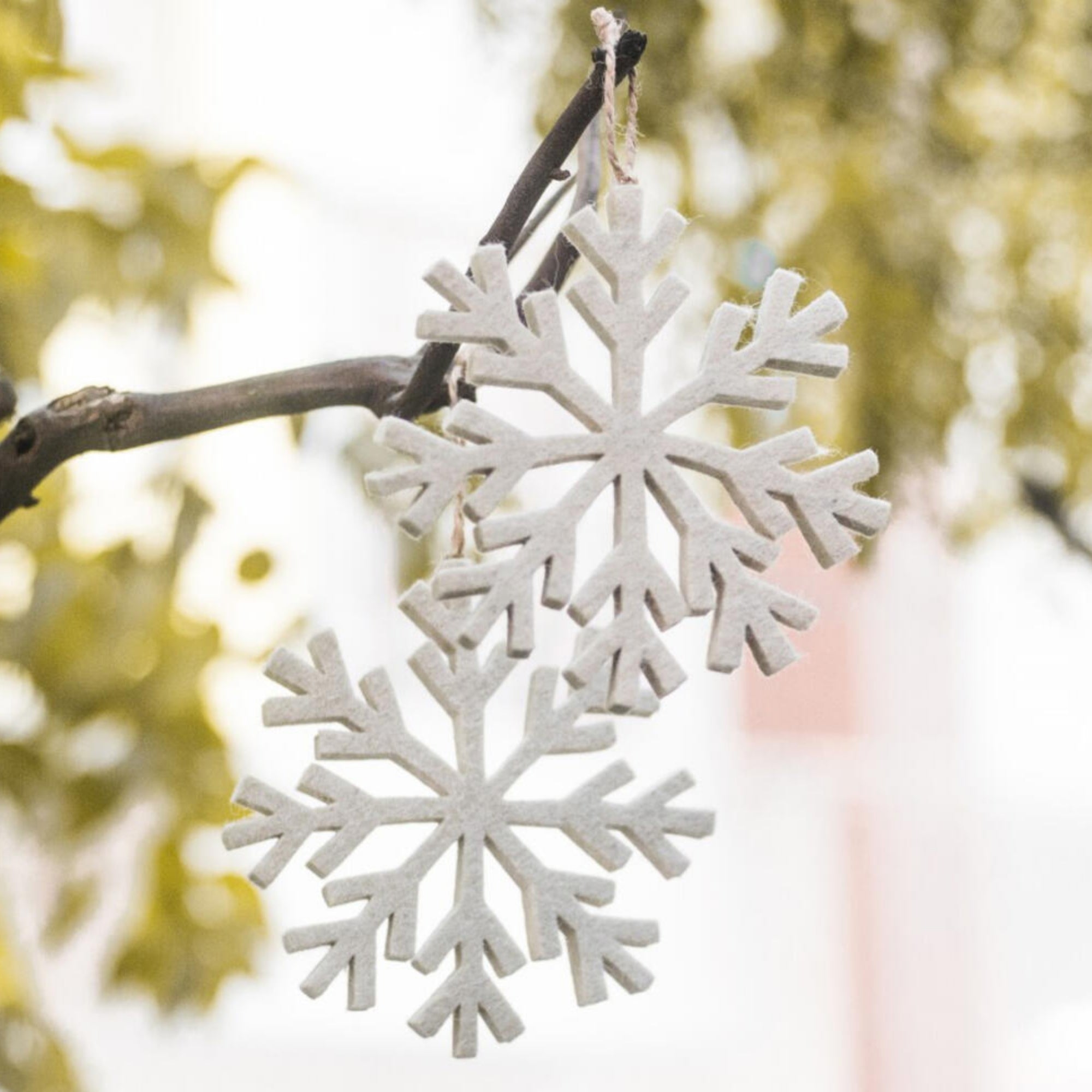 Felt snowflake decorations, hand-stitched in India, set of two