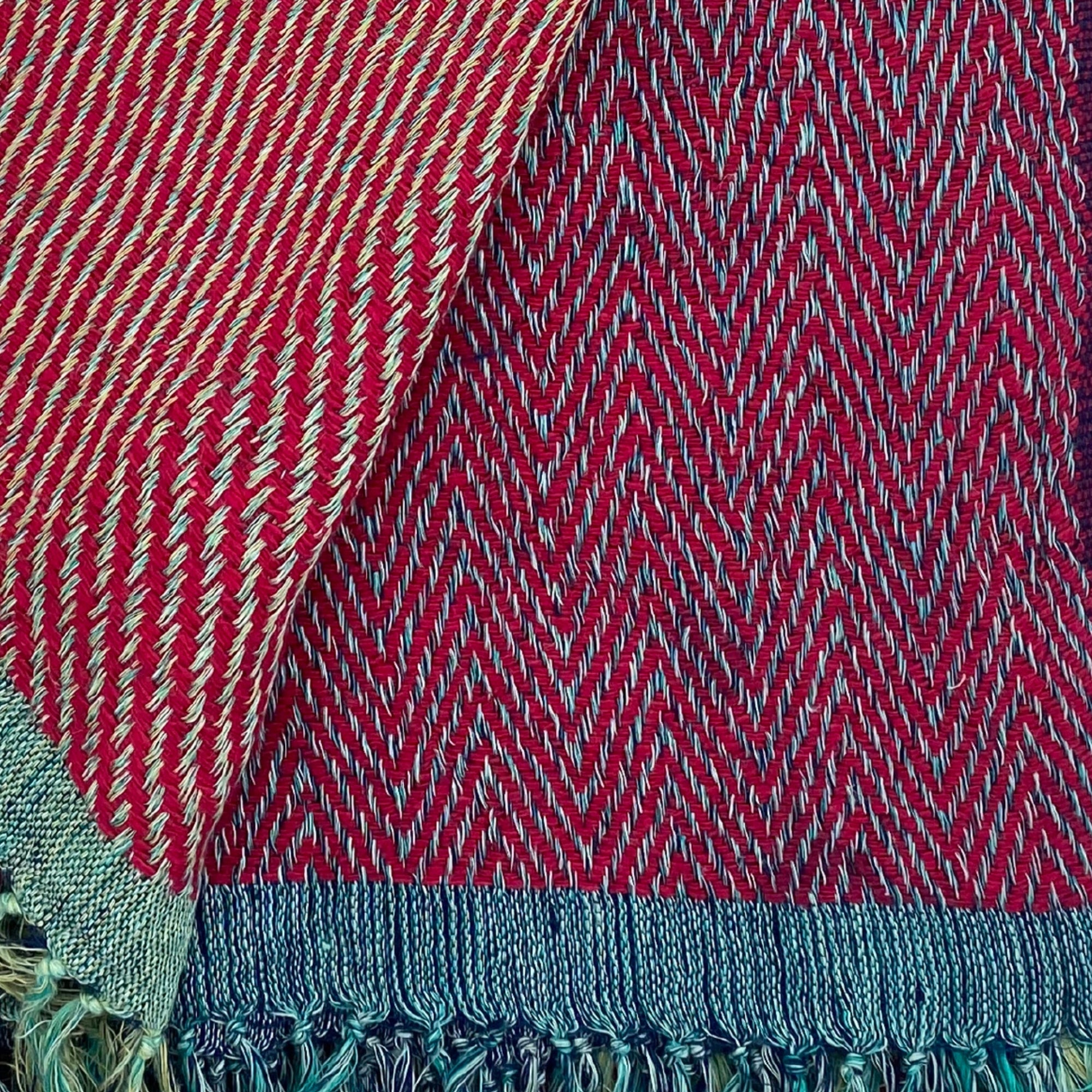 Handwoven silk and linen throw in warm red tones with bi-colour tassels, 130 x 170 cm