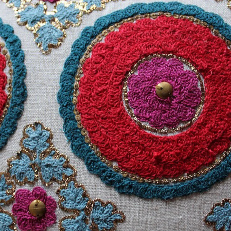 Suzani Kokand linen cushion, gold sitara needlework, close view