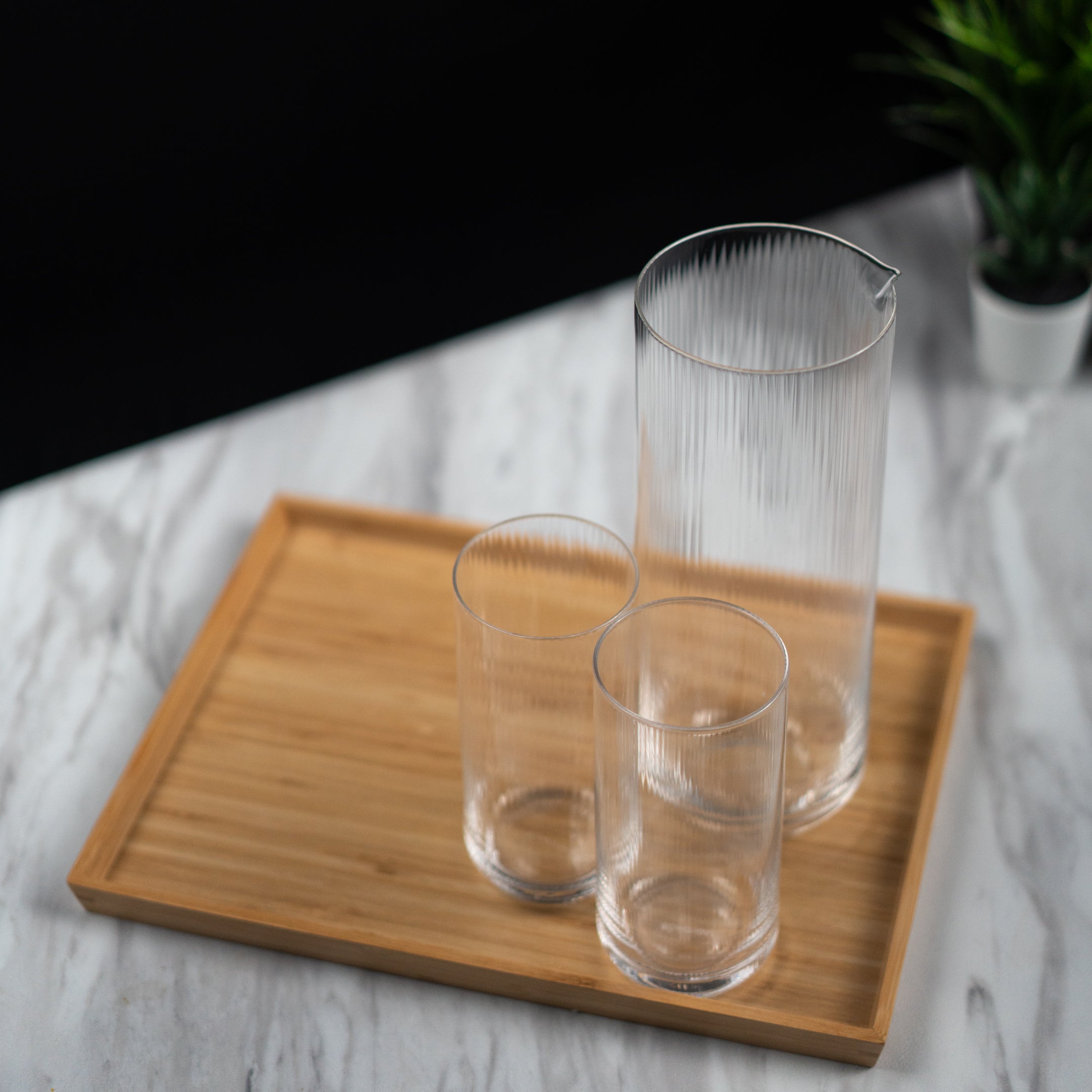 Optic carafe in clear mouth-blown glass, subtle ribbed texture, detail view