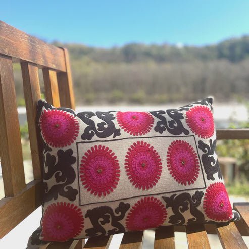 Hand-embroidered Suzani linen cushion in a red, pink and black palette with metalwork detail, 35 by 50 cm, by Saamro