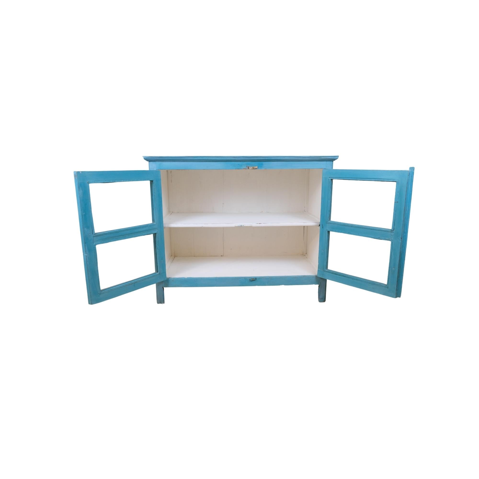Turquoise painted teak glass-front cabinet, styled