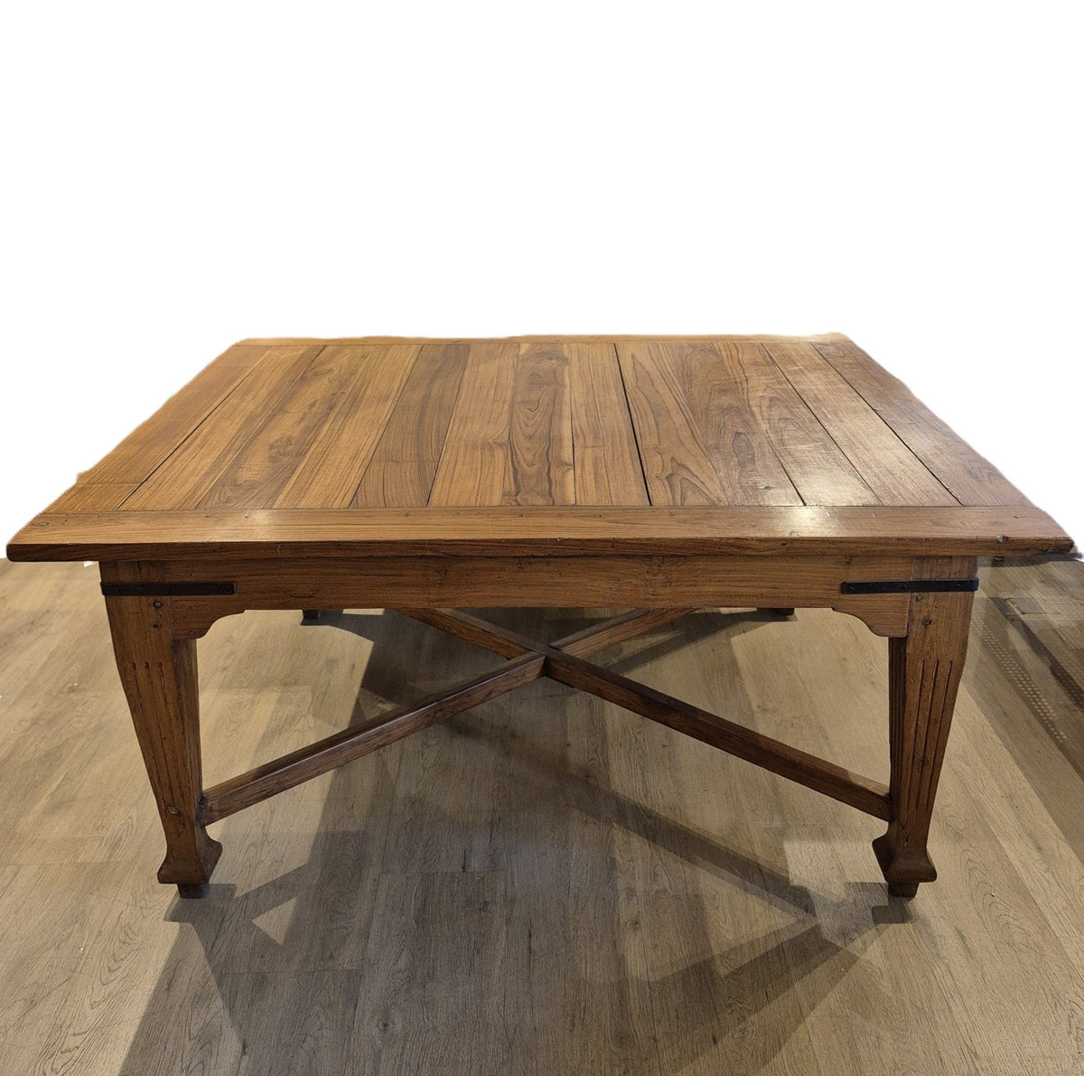 Square teak dining table closed to 130cm by 130cm, with fine proportions and two extension leaves stored for larger dinners