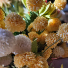 Lifelike small artificial bubble dahlias in yellow and white