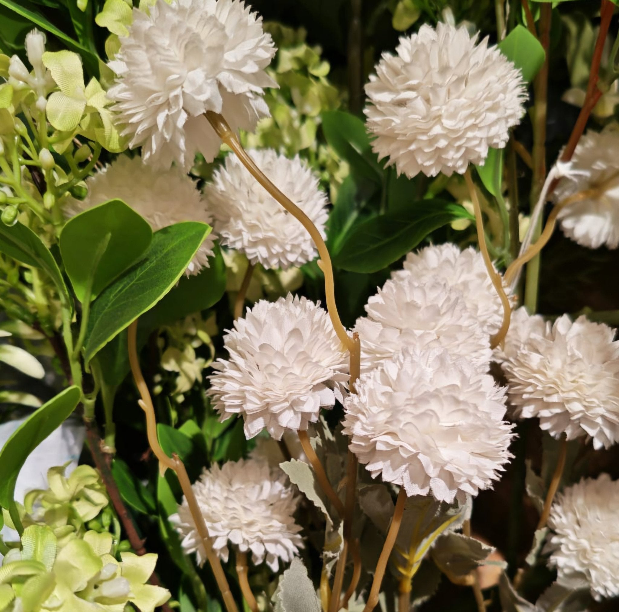 Small bubble dahlia in white, close up of an artificial flower