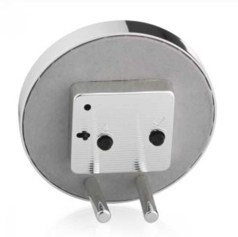 Back view of round alarm clock, finished in grey velvet