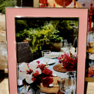 Coral enamel frame by Addison Ross, styled with a photo in portrait orientation