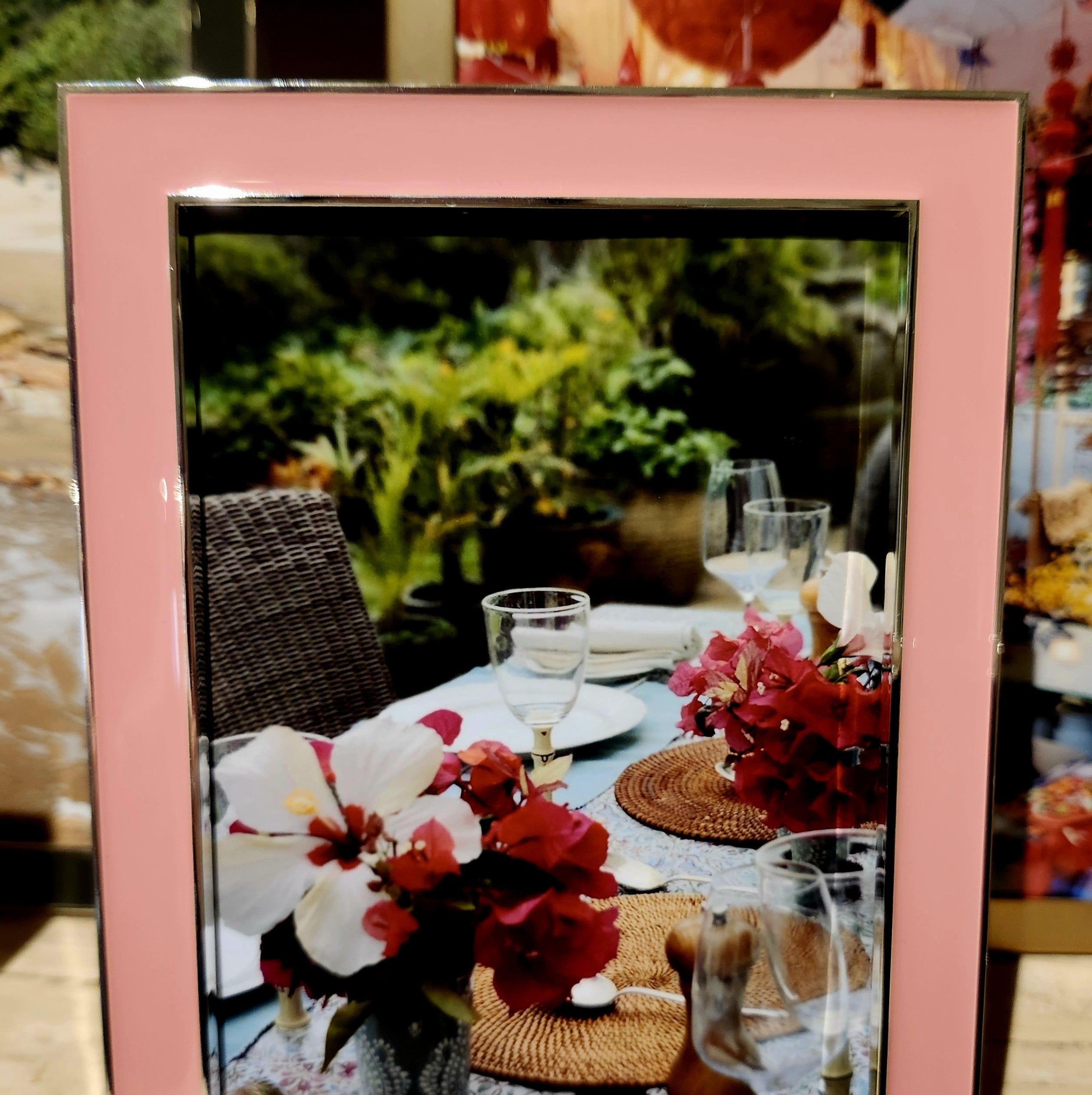 Coral enamel frame by Addison Ross, styled with a photo in portrait orientation