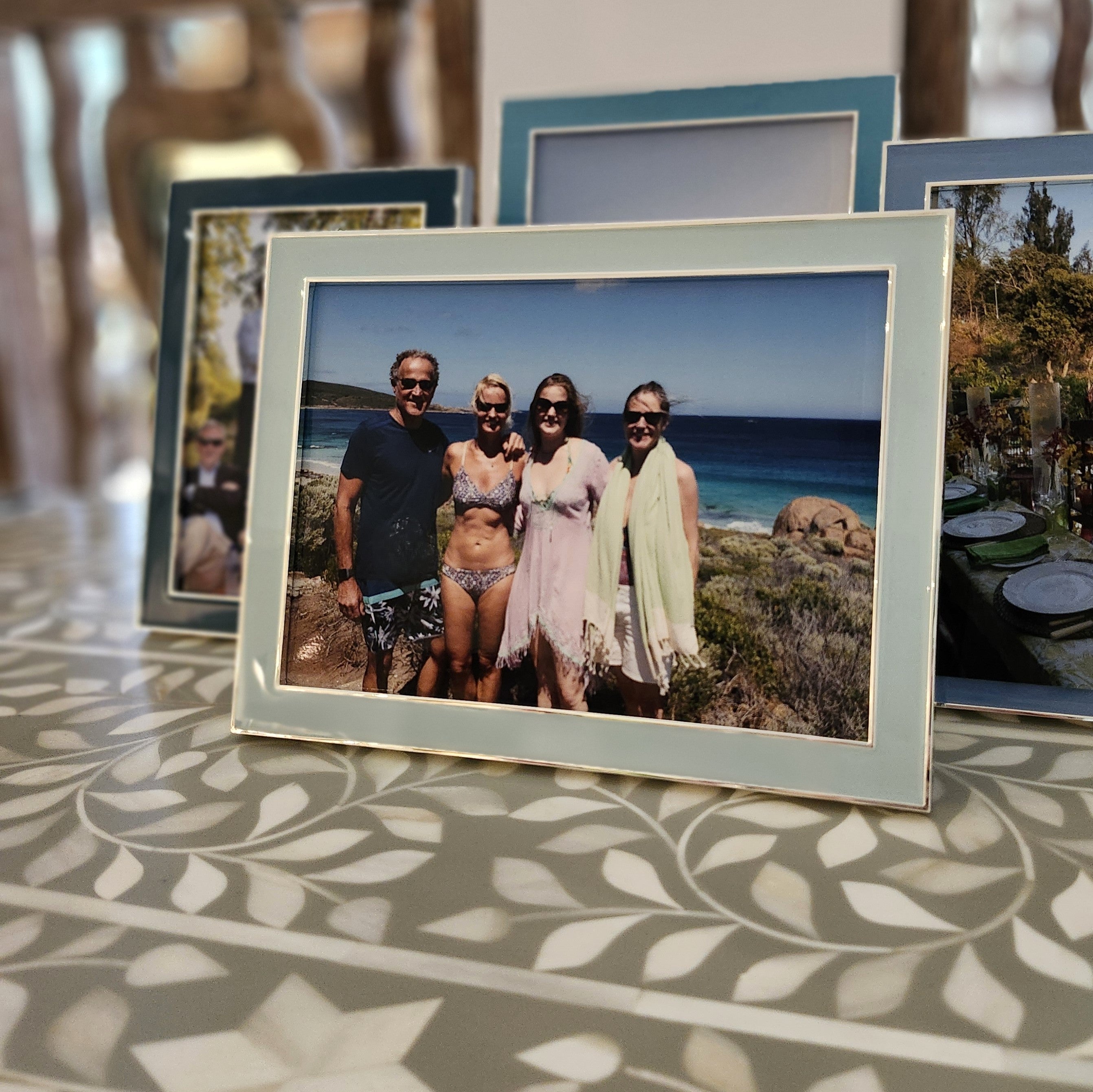 Powder blue enamel frame by Addison Ross, styled with a photo in portrait orientation