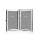 White enamel travel double frame by Addison Ross, open to show two 2 x 3 inch portrait slots
