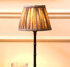 Bronze bamboo lamp with a beige herringbone shade, Addison Ross