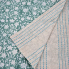 Reversible table runner with block print floral green on one side and woven cotton stripes on the other