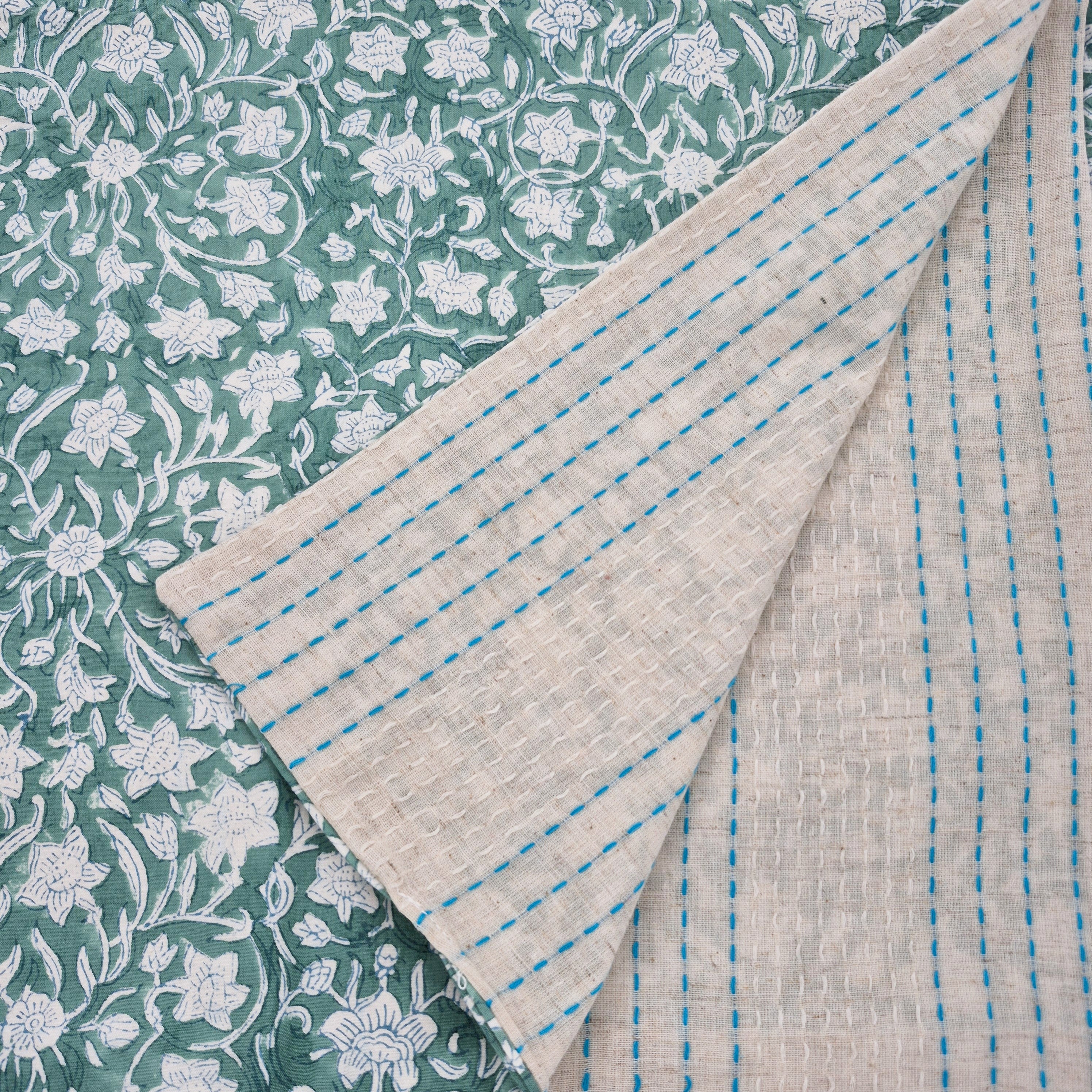 Reversible table runner with block print floral green on one side and woven cotton stripes on the other